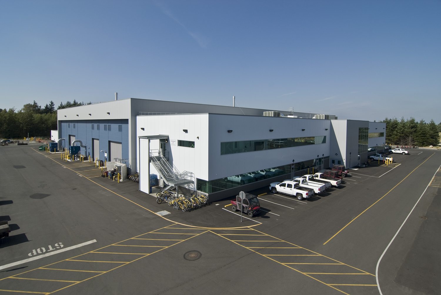 Completed maintenance shop and offices at the BP Cherry Point facility with fleet trucks parked outside