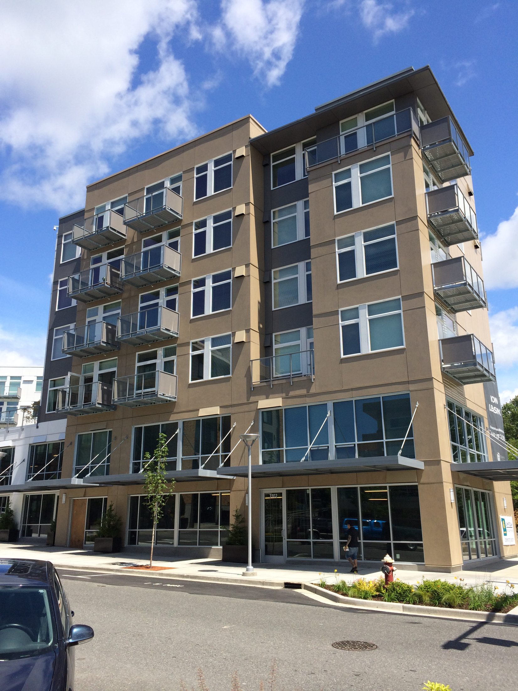 The Cornerstone's Newmarket Street elevation with ground-floor storefronts and residential balconies, Bellingham, Washington