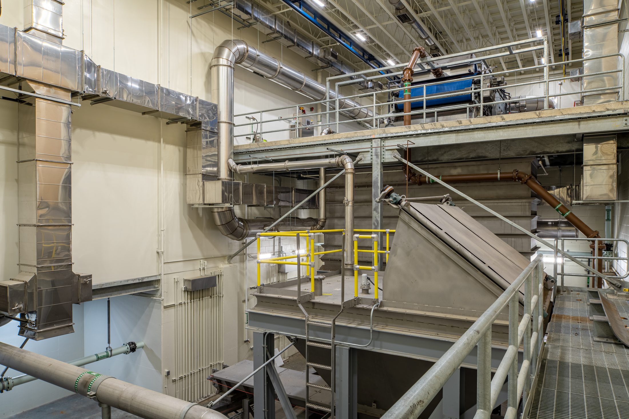 Belt filter press and stainless ductwork inside the MWWTP Biosolids Dryer Facility, Juneau