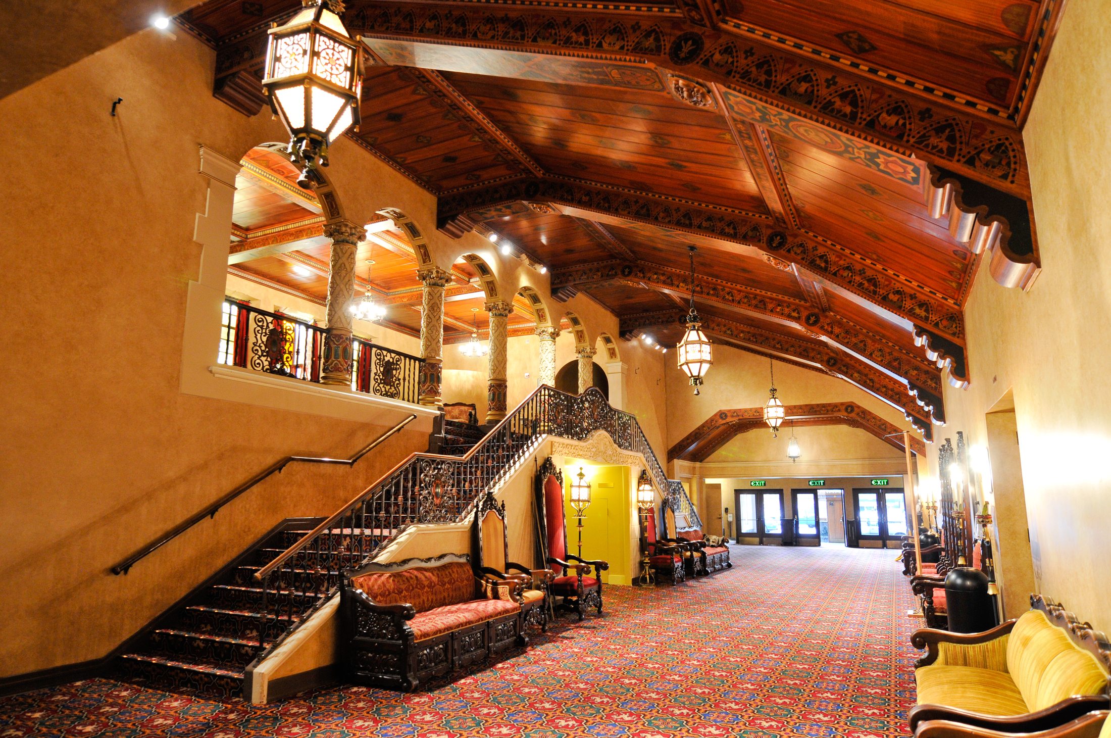Restored grand lobby of the 1927 Mt. Baker Theatre with ironwork staircase and painted timber ceiling