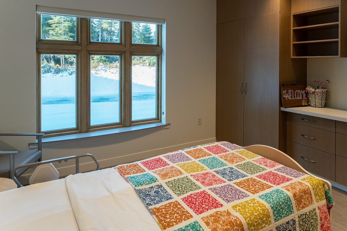 Long-term care resident room with quilted bed and water views at Wrangell Medical Center
