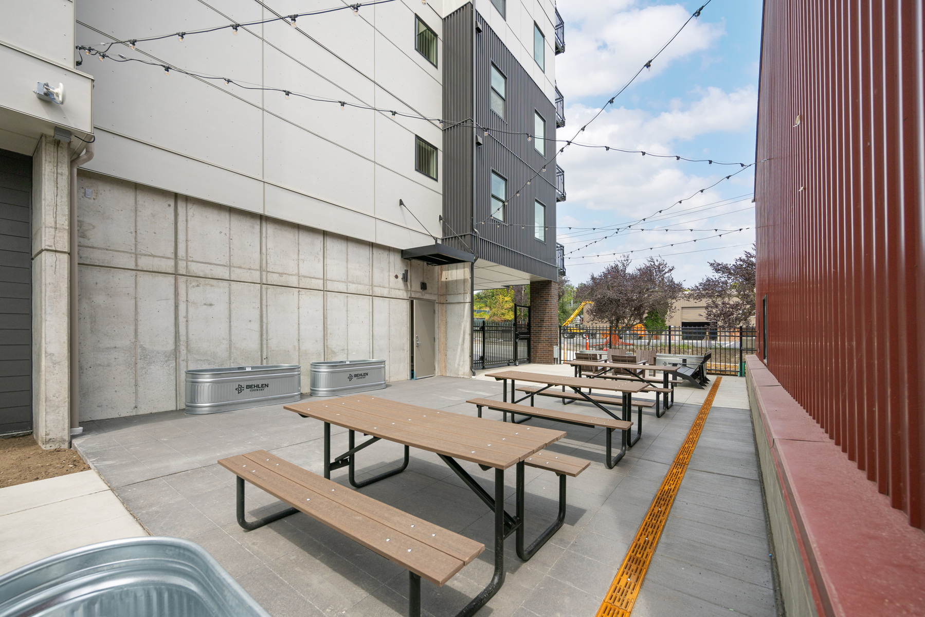 Block 6 courtyard with picnic tables and string lights
