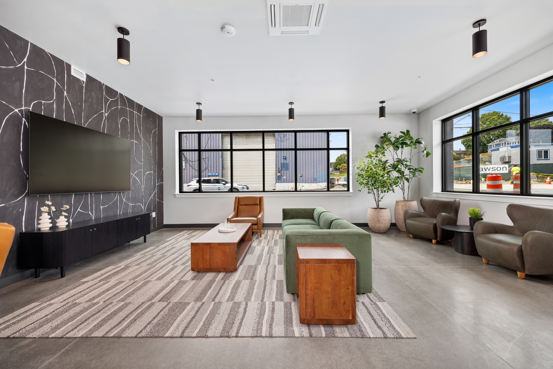 Common lounge with green sofas at Block 6