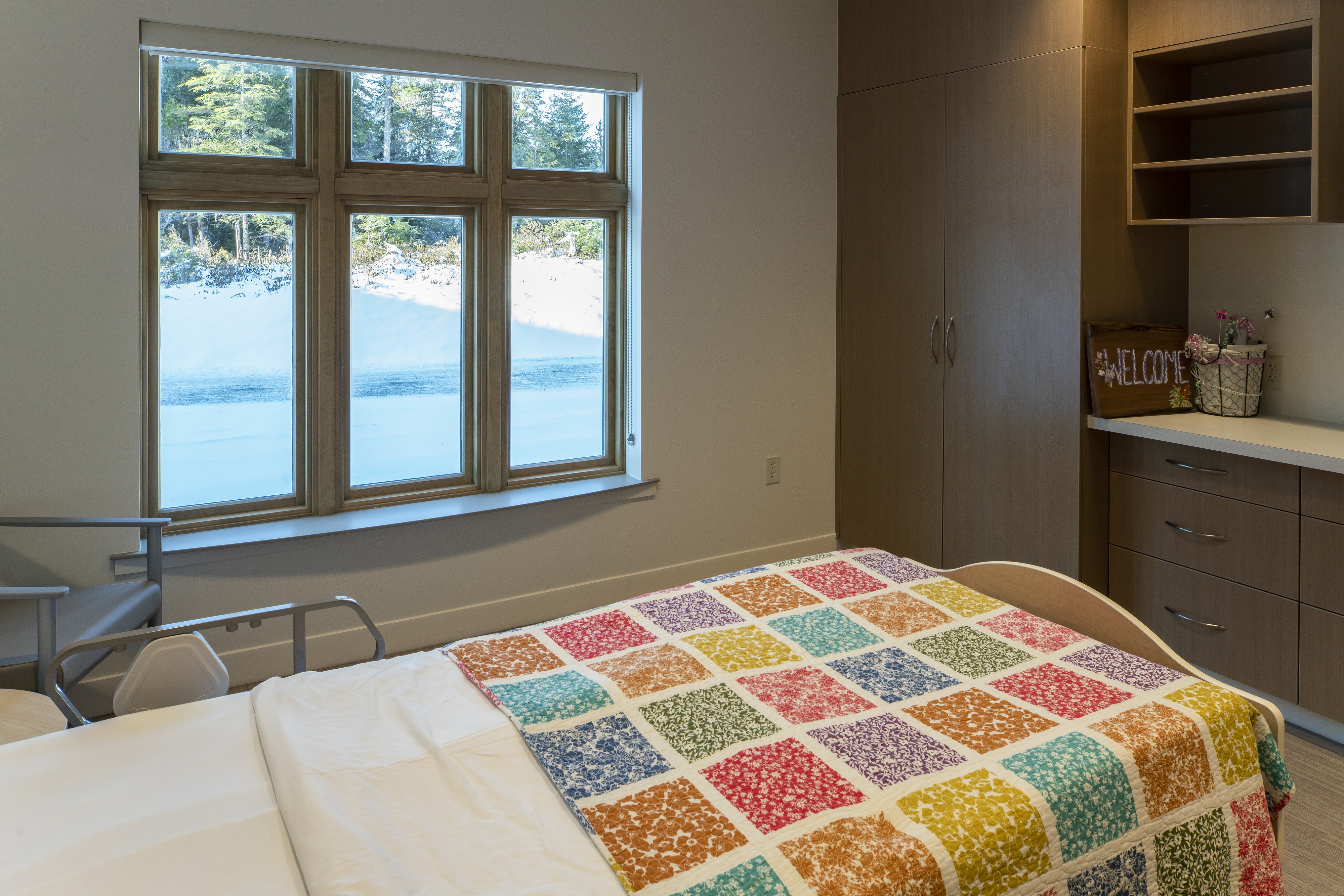 Long-term care resident room with quilted bed and water views at Wrangell Medical Center