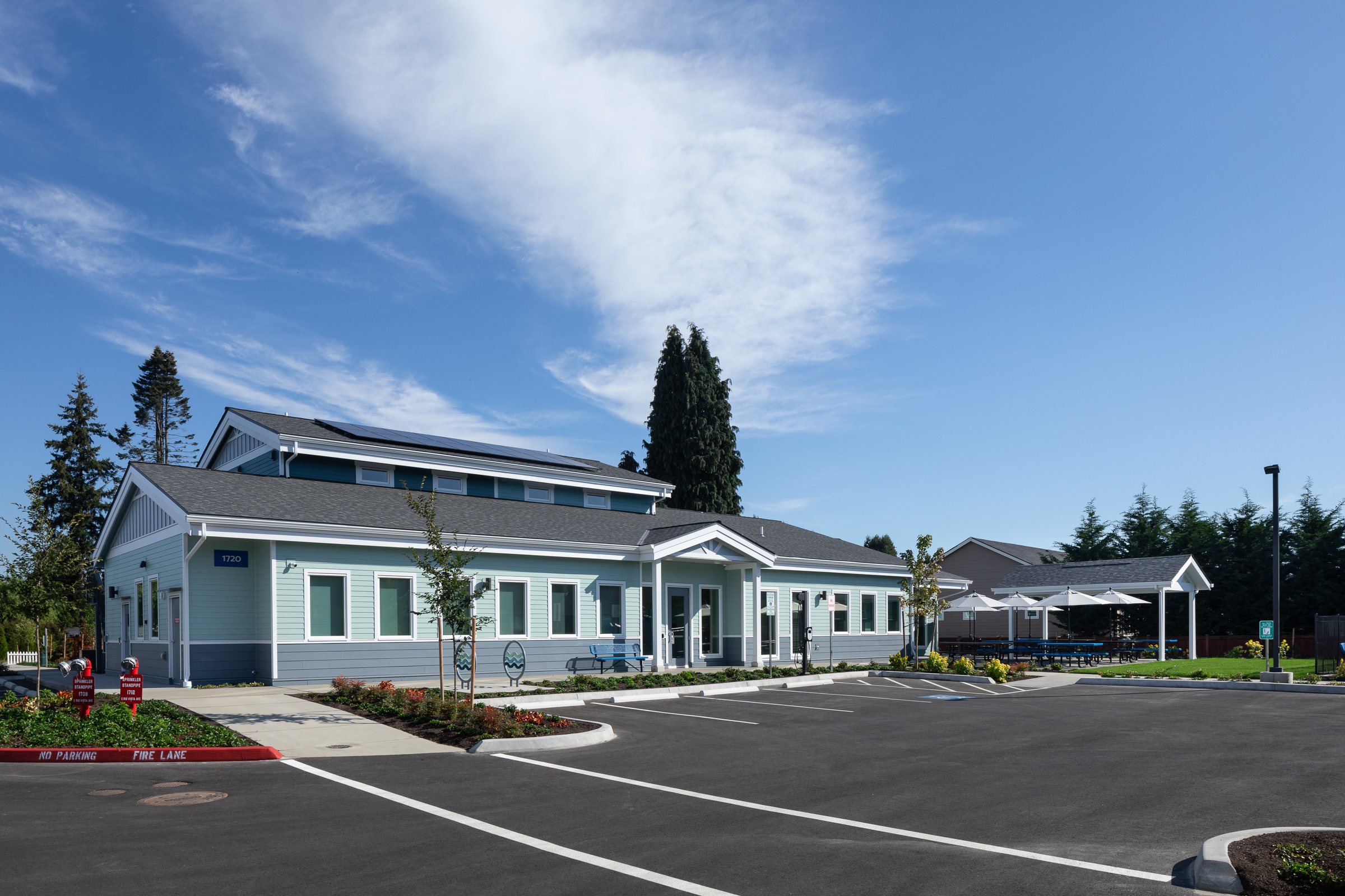 Resident services building at Ballington Flats beside a tall evergreen