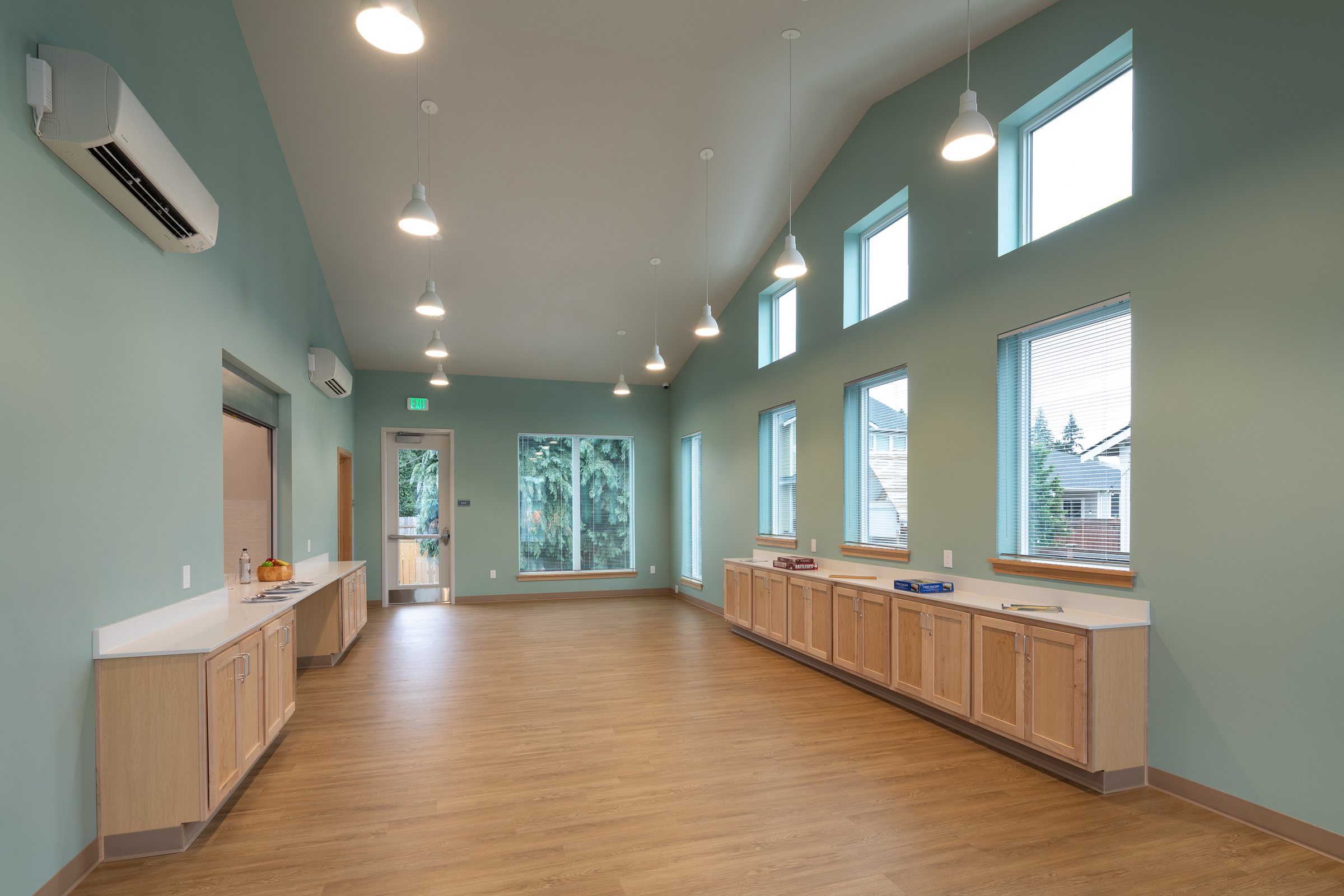 Community room with clerestory windows in the Ballington Flats resident services building