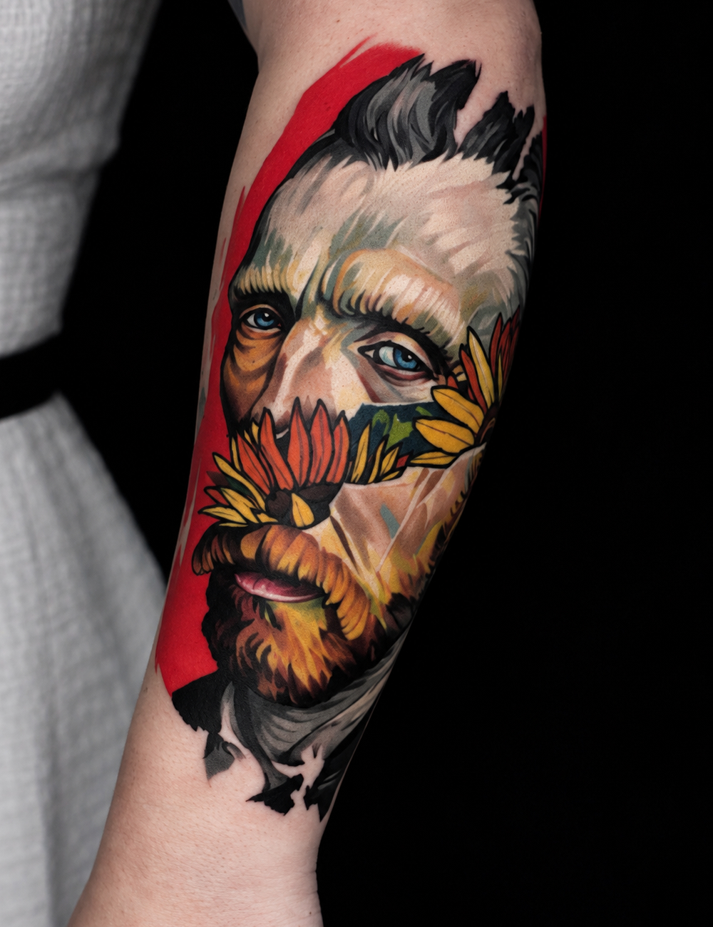 Color realism forearm tattoo of a Van Gogh portrait with sunflowers by Jesus