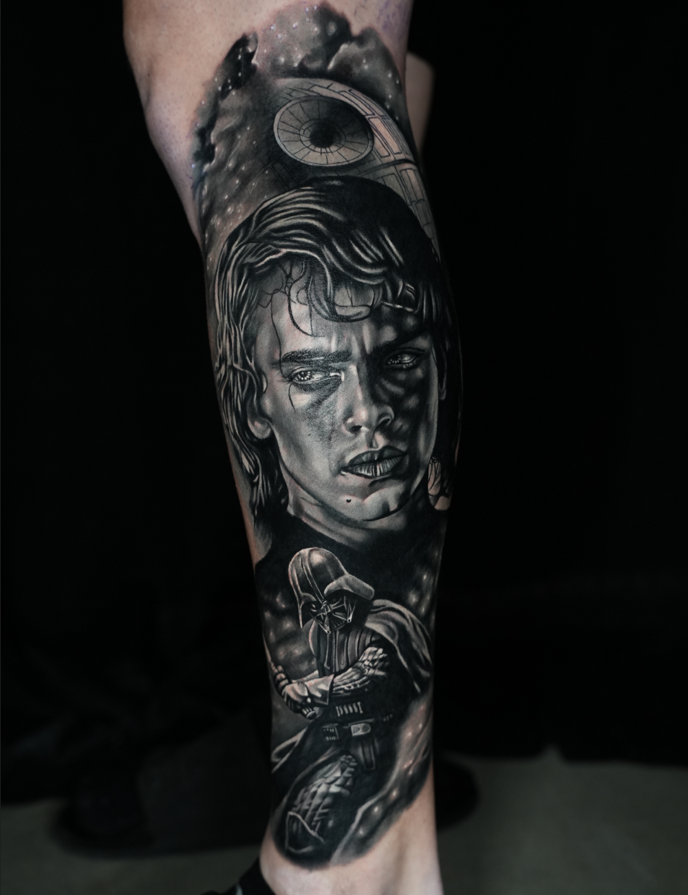 Black and grey realism leg tattoo of Anakin Skywalker with Darth Vader and the Death Star by Juanky