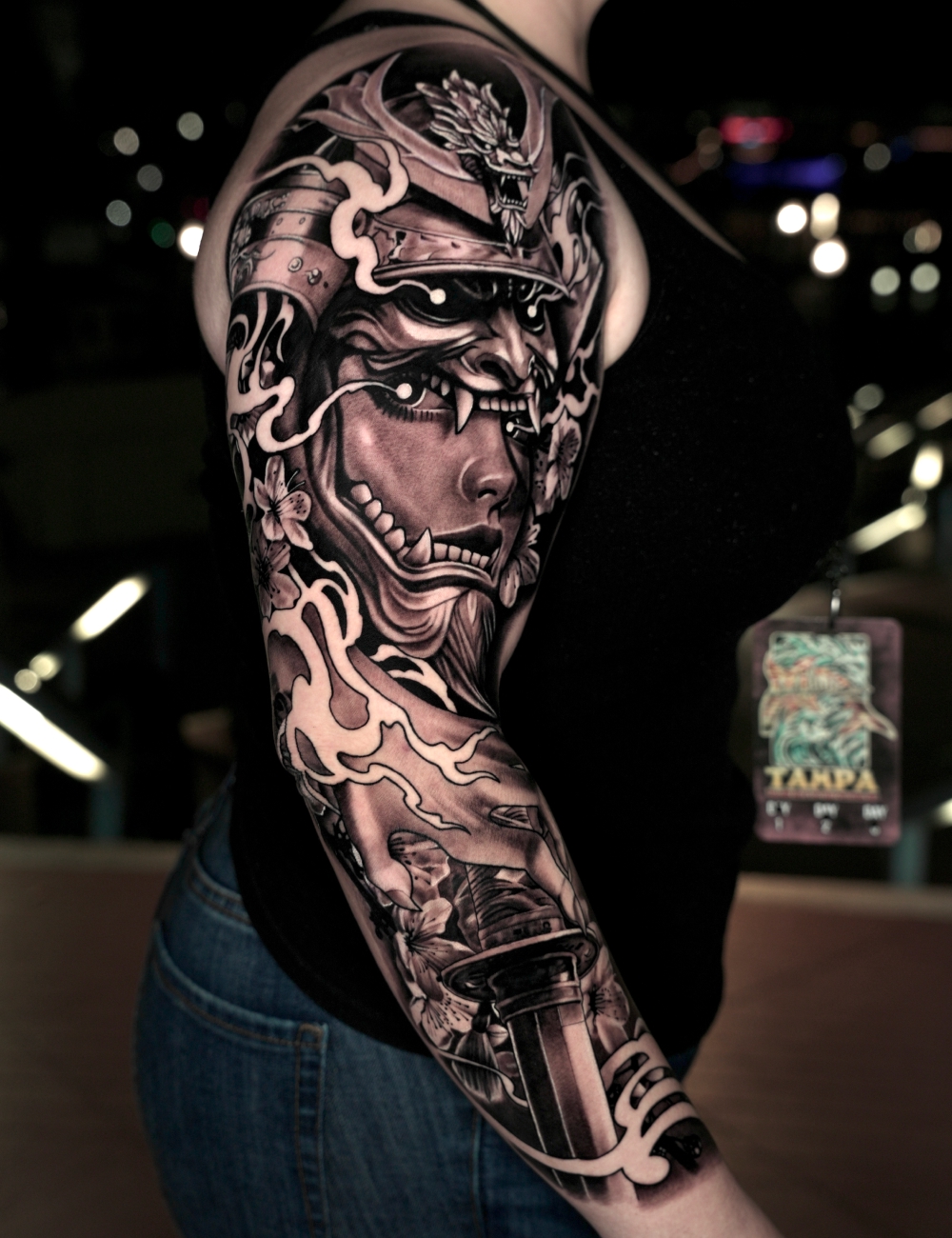 Black and grey Japanese full sleeve tattoo of a samurai helmet with a demon mask by Juanky