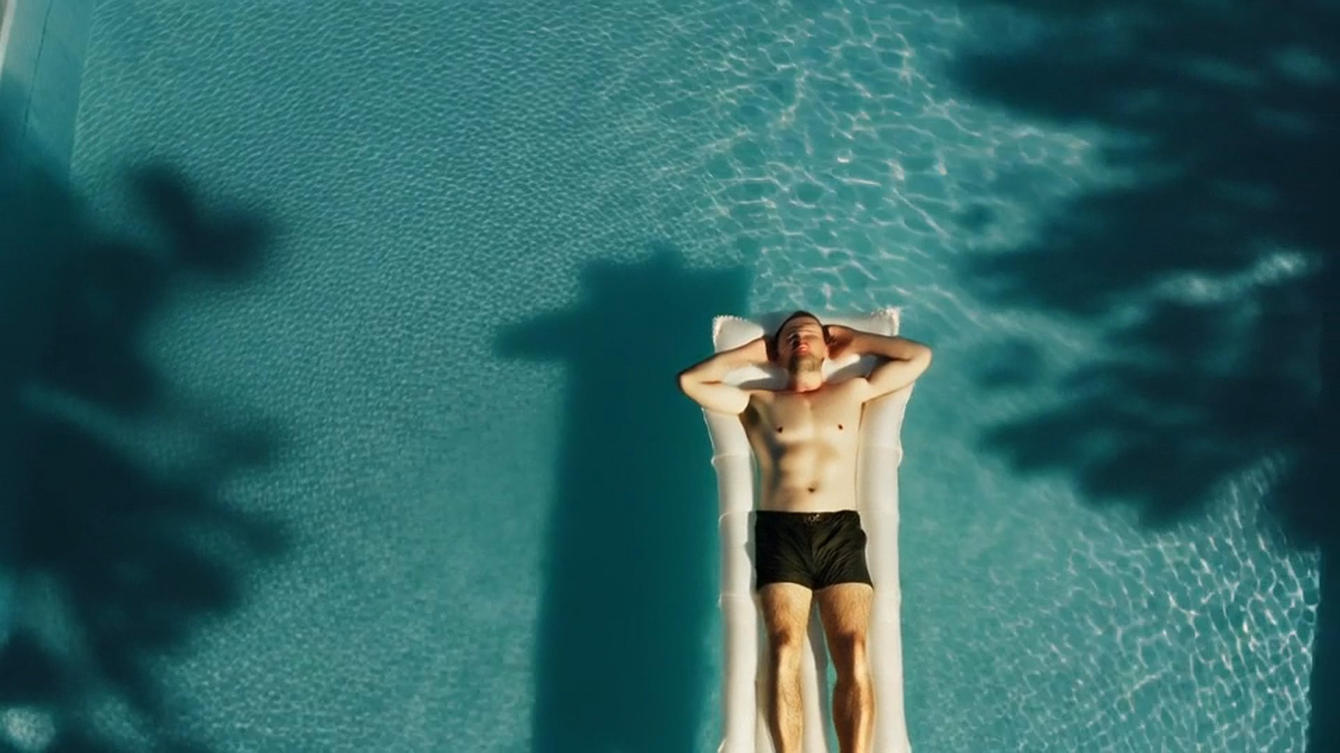 MedBud hero background - man relaxing on pool lilo