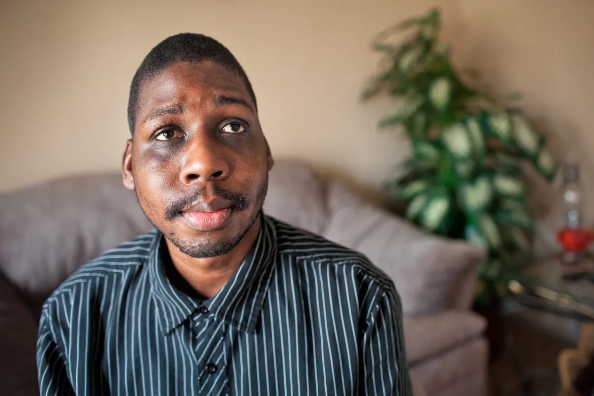 A person who is experiencing disability  in a living room