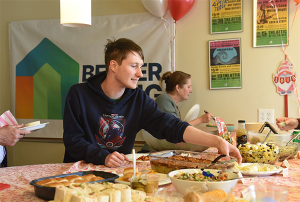 A young man with a disability at a buffet at a BLT event