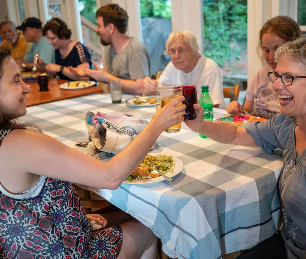A group of people sitting around a table and having a meal