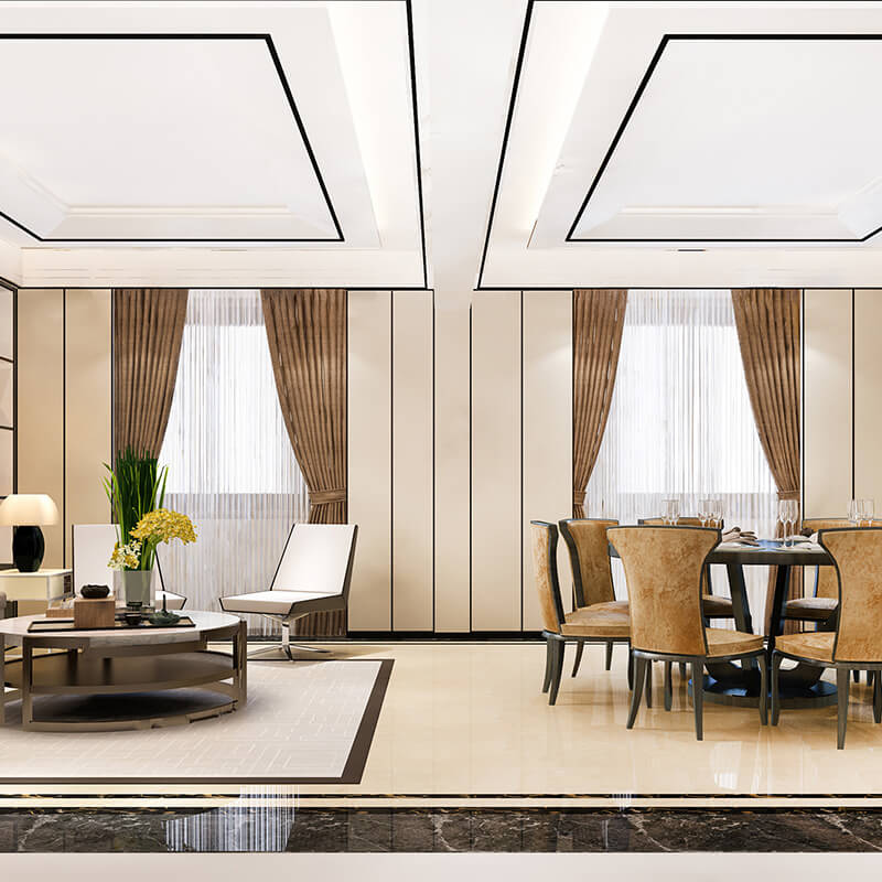 Modern living and dining area with beige walls, brown curtains, comfortable chairs, a round dining table, and a coffee table with decorative plants.