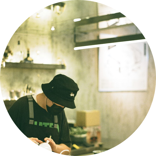 Smiling man holding a set of house keys inside a well-lit modern store.