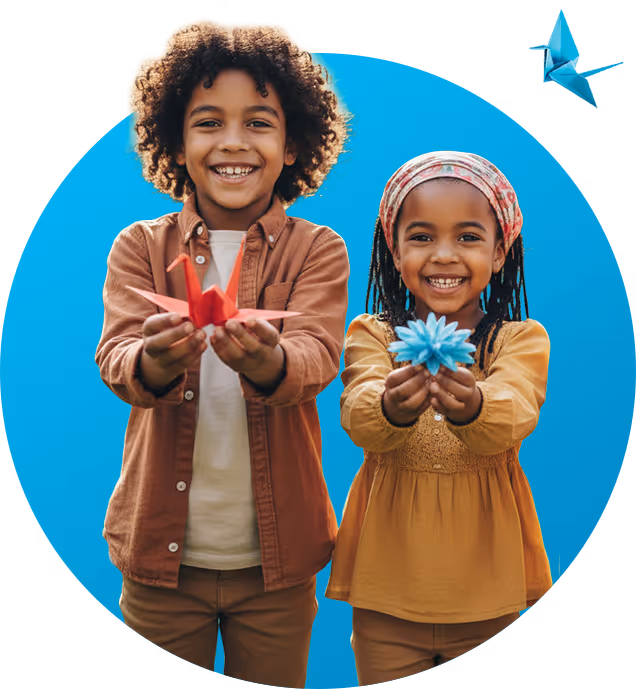 Two smiling kids holding origami