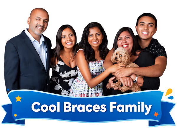 Smiling family of five with a small dog behind a banner reading 'Cool Braces Family.'