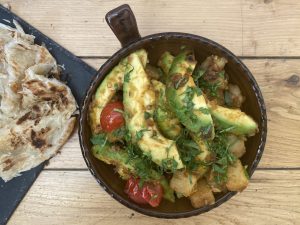Bowl of Jeera Avocado: Creamy avocados and flavorful cumin-infused potatoes.