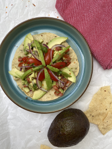 Avocado Masala Papad: Crispy papad topped with a zesty blend of mashed avocado, tangy spices, and fresh herbs.