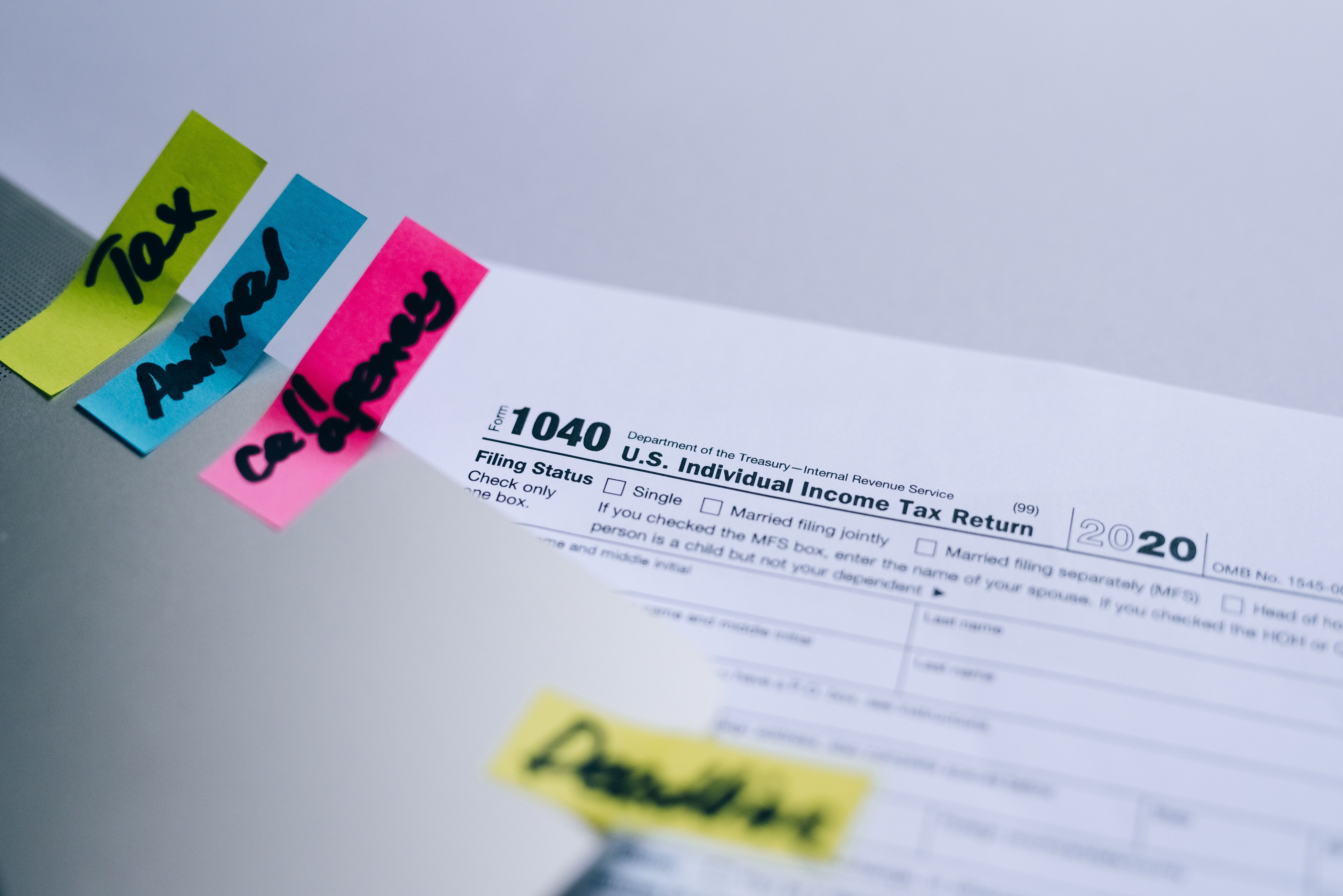 U.S Individual Tax Return form with highlighted sticky note tabs.