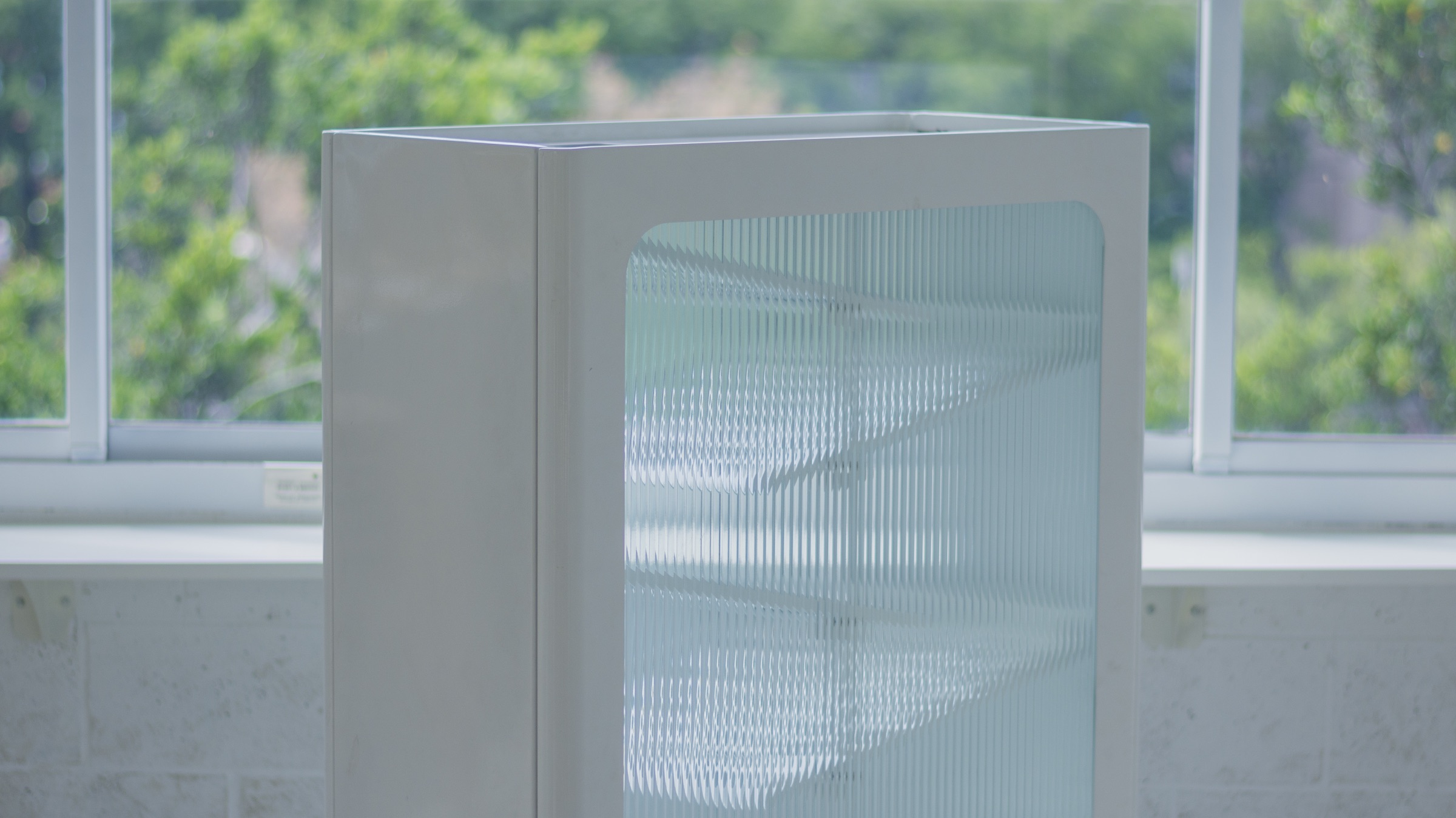 The recycling bin in a window-lit interior