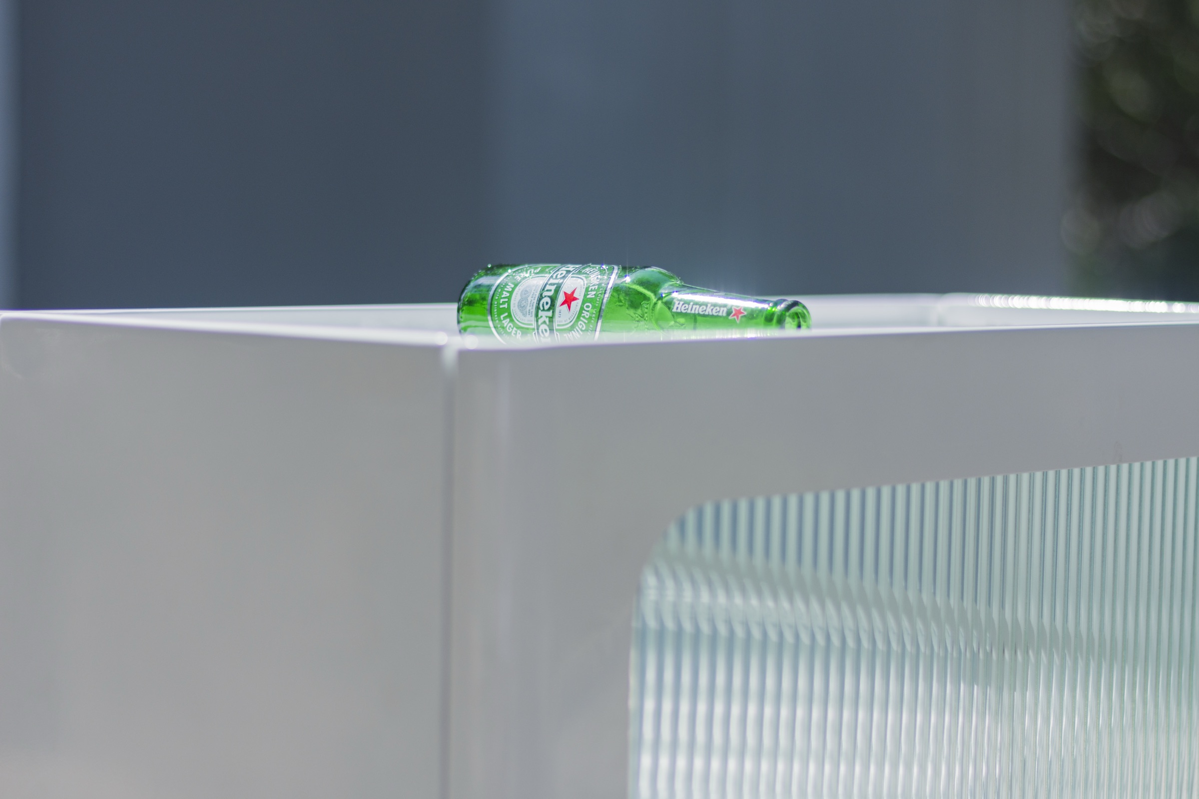 A green bottle resting in the bin's top insertion slot