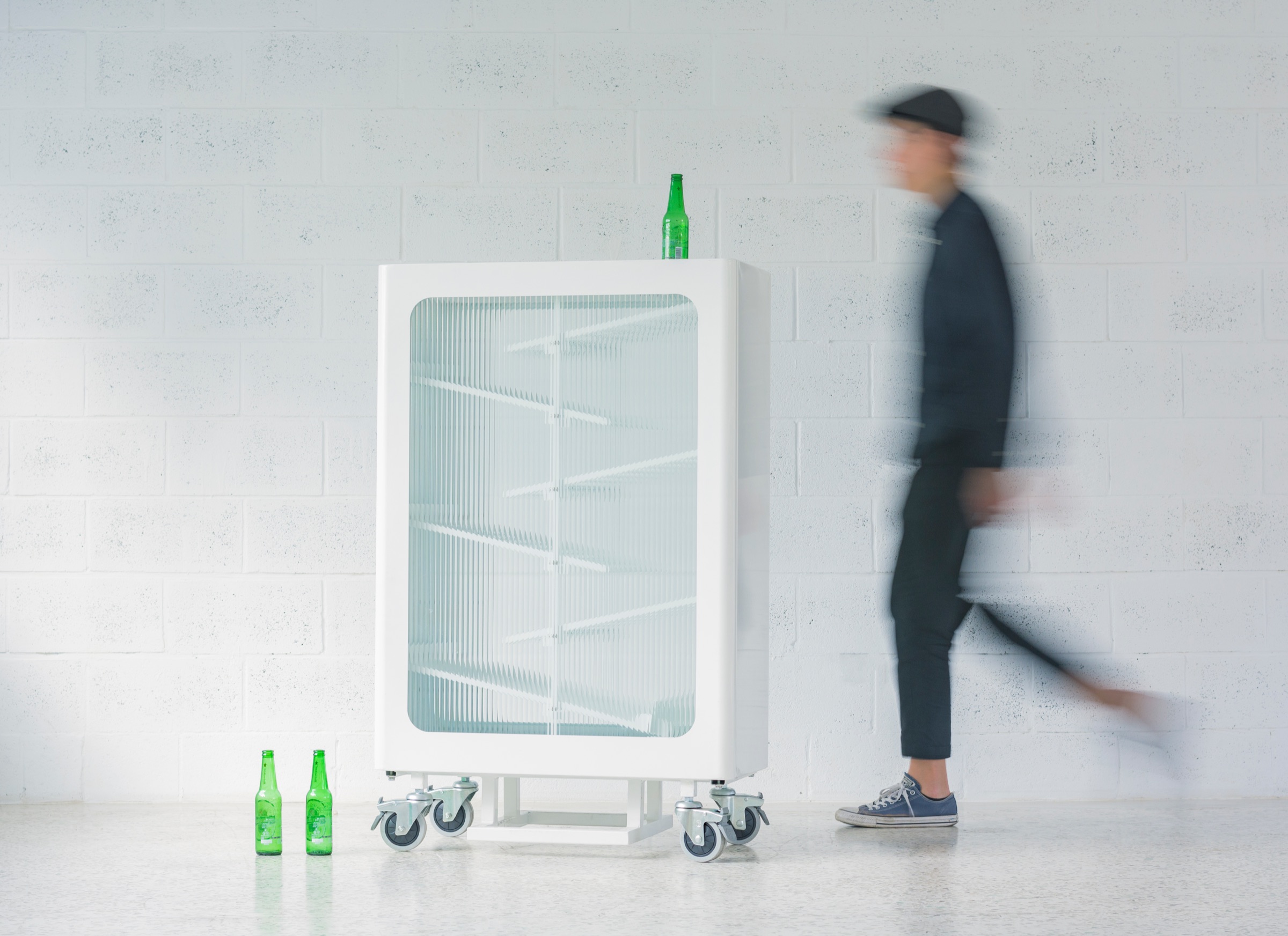 A person walking past the recycling bin in motion blur