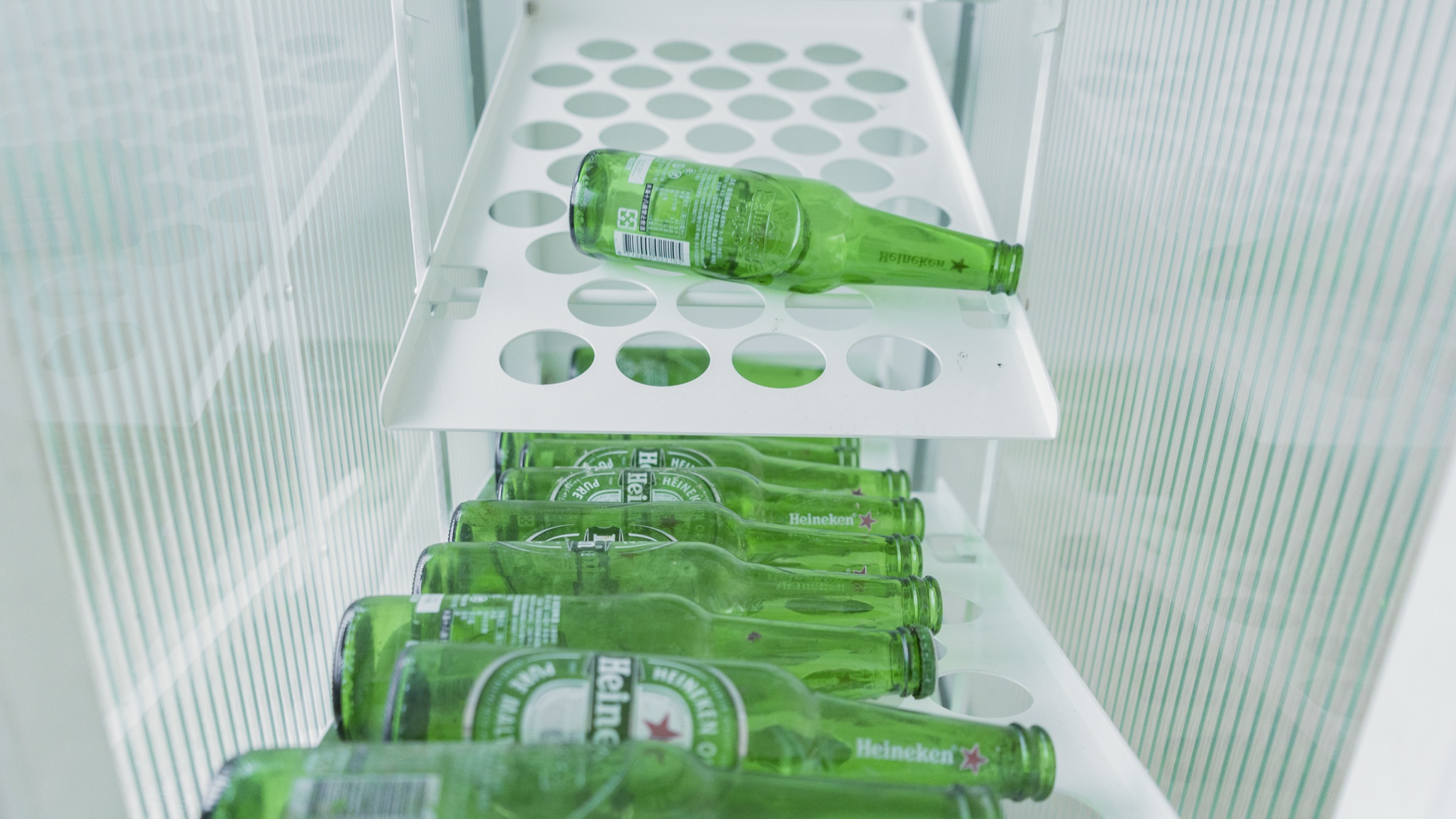 Green bottles arranged on the perforated shelves