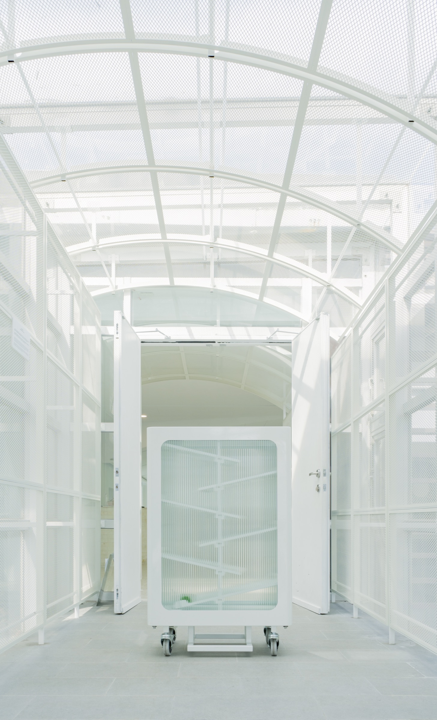 The recycling bin seen down a skylit corridor