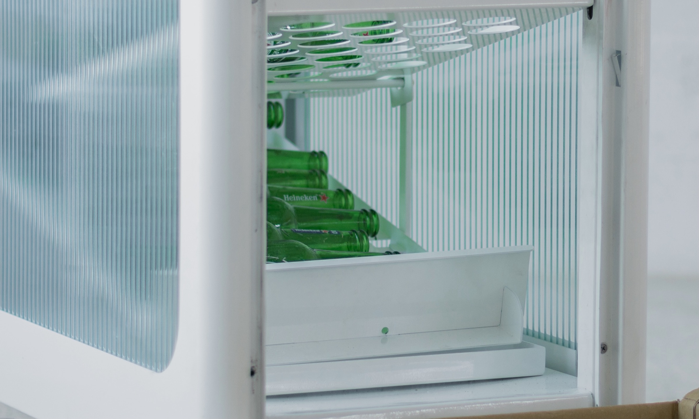 The open side door revealing the bottle collection tray