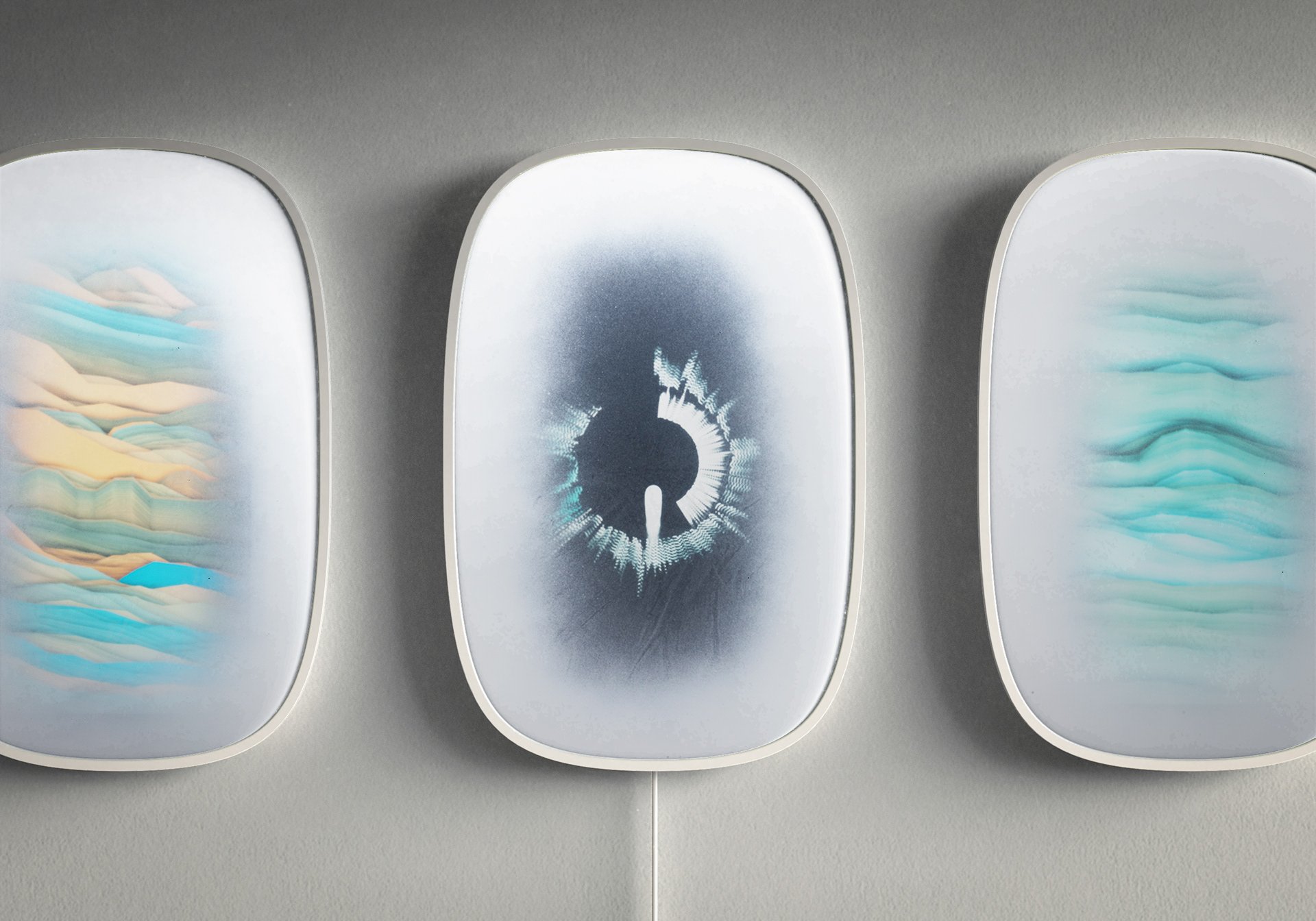 Three SOUNDMATE FRAME panels on a wall, each showing a different real-time sound visualisation