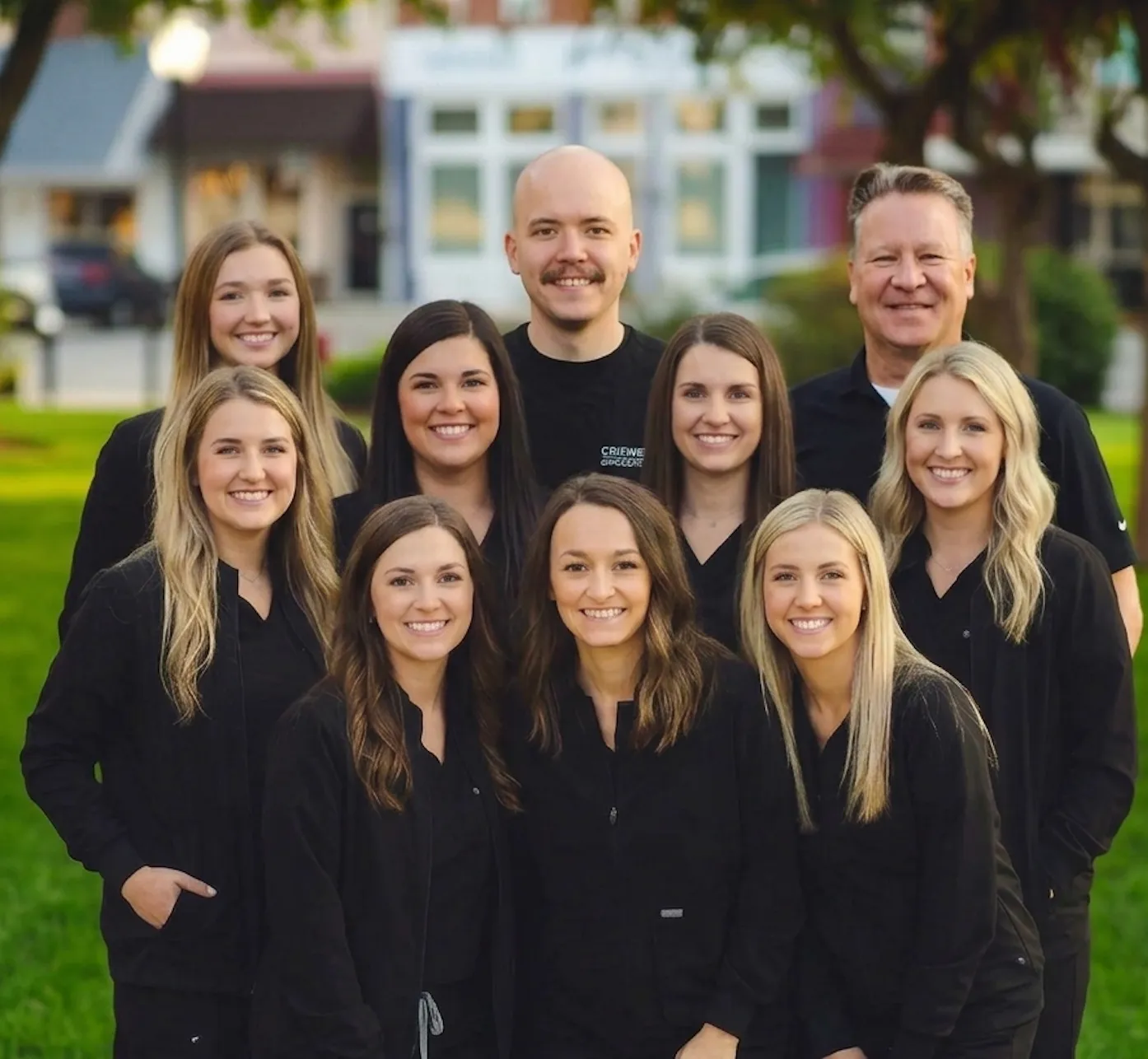 Portrait of a Markham Family Dental Associates team member standing outdoors on a tree-lined sidewalk in Harlan