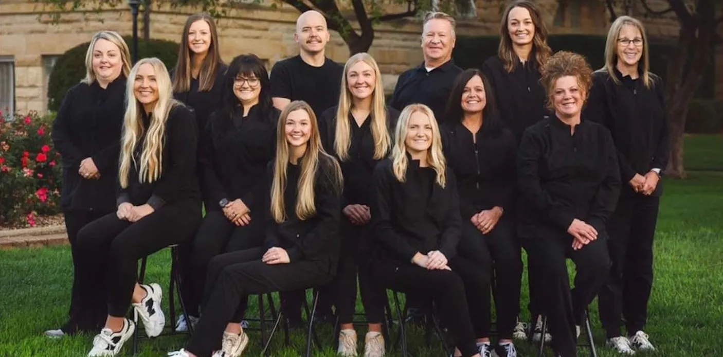 The Markham Family Dental Associates team posed together outside the Harlan office