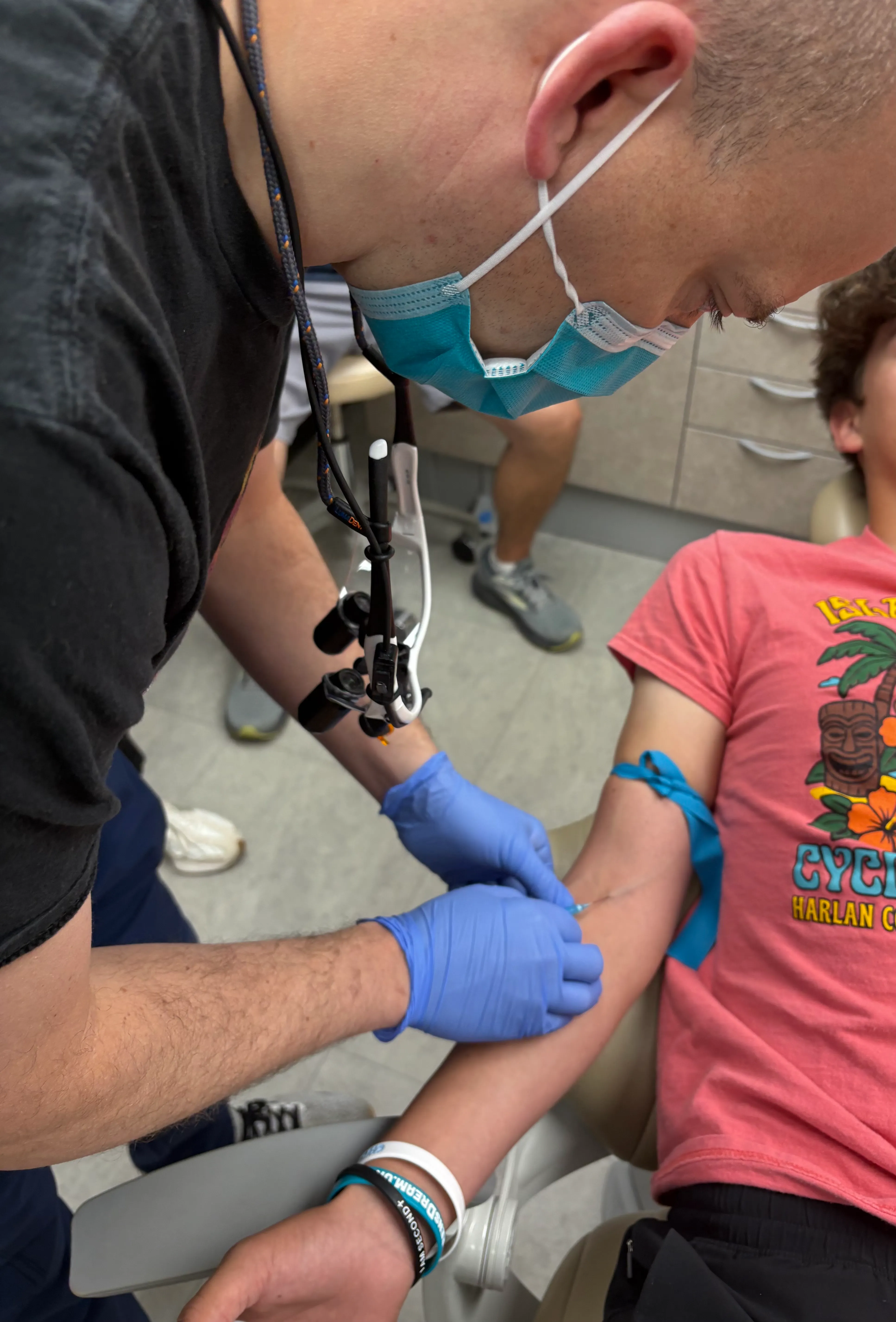 A patient receiving IV sedation through a line placed in the arm