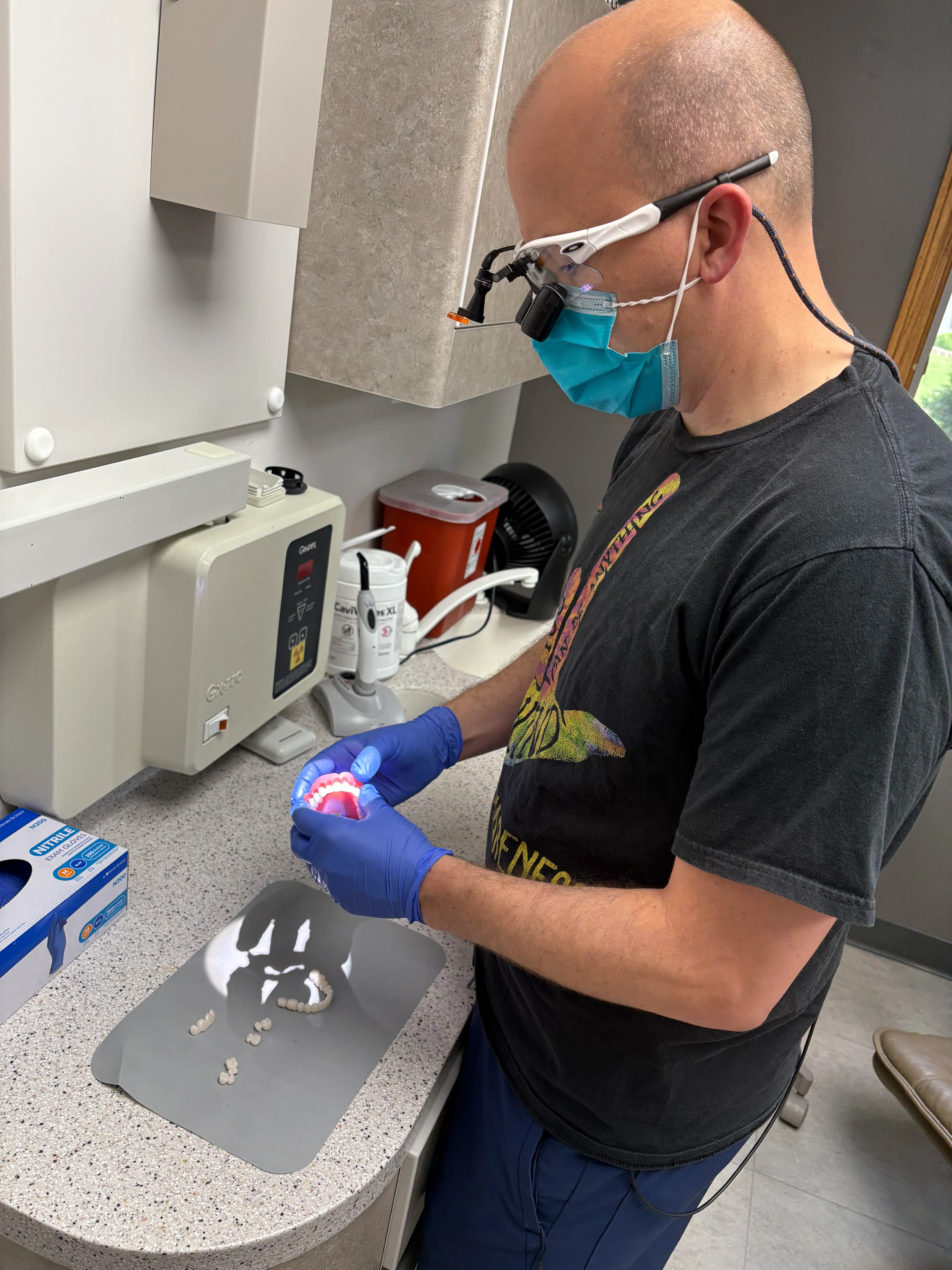 Dr. Roy Burkhalter crafting a dental restoration in the in-house lab