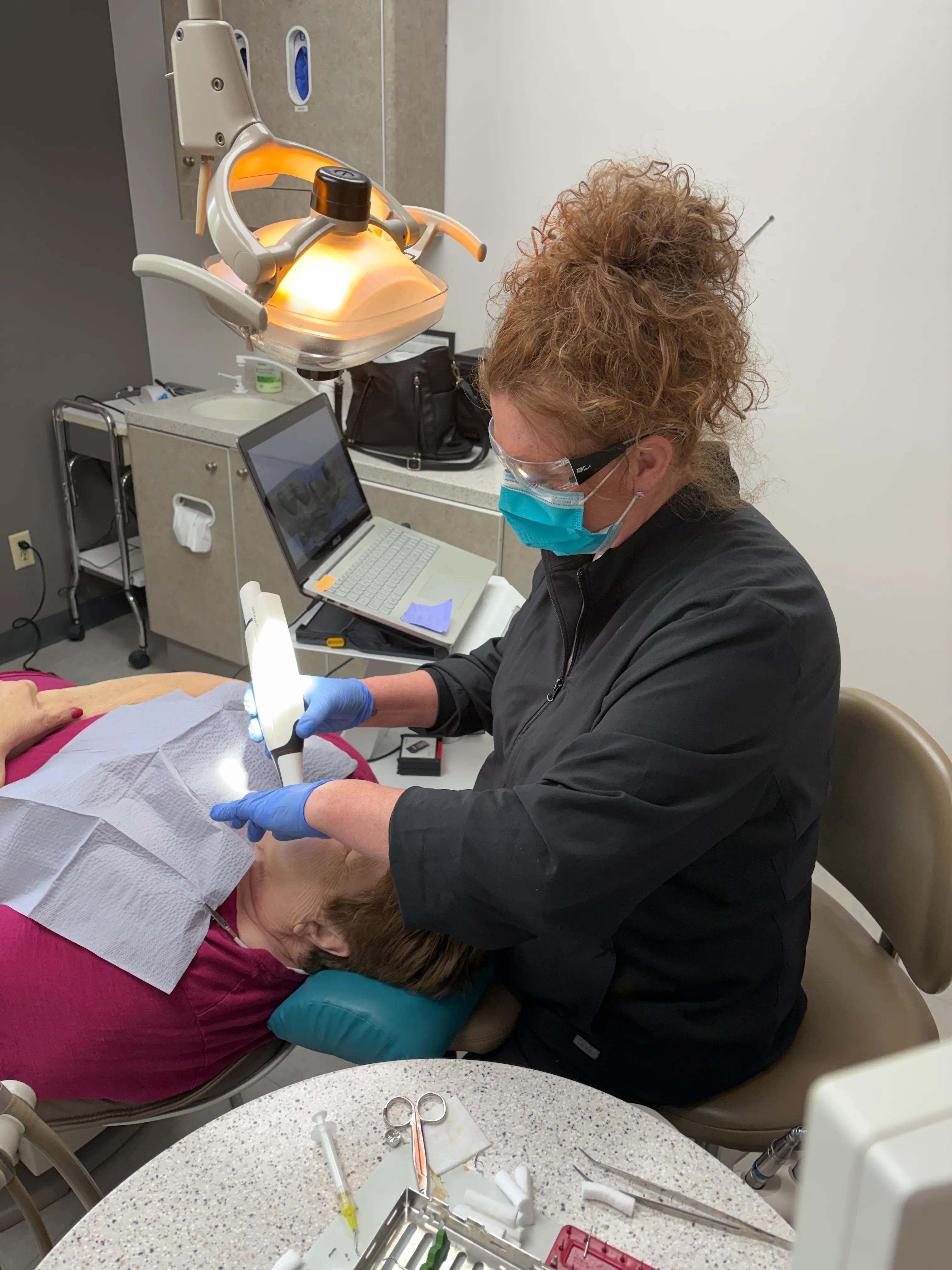 Dr. Phillip Markham examining a patient's teeth during a checkup