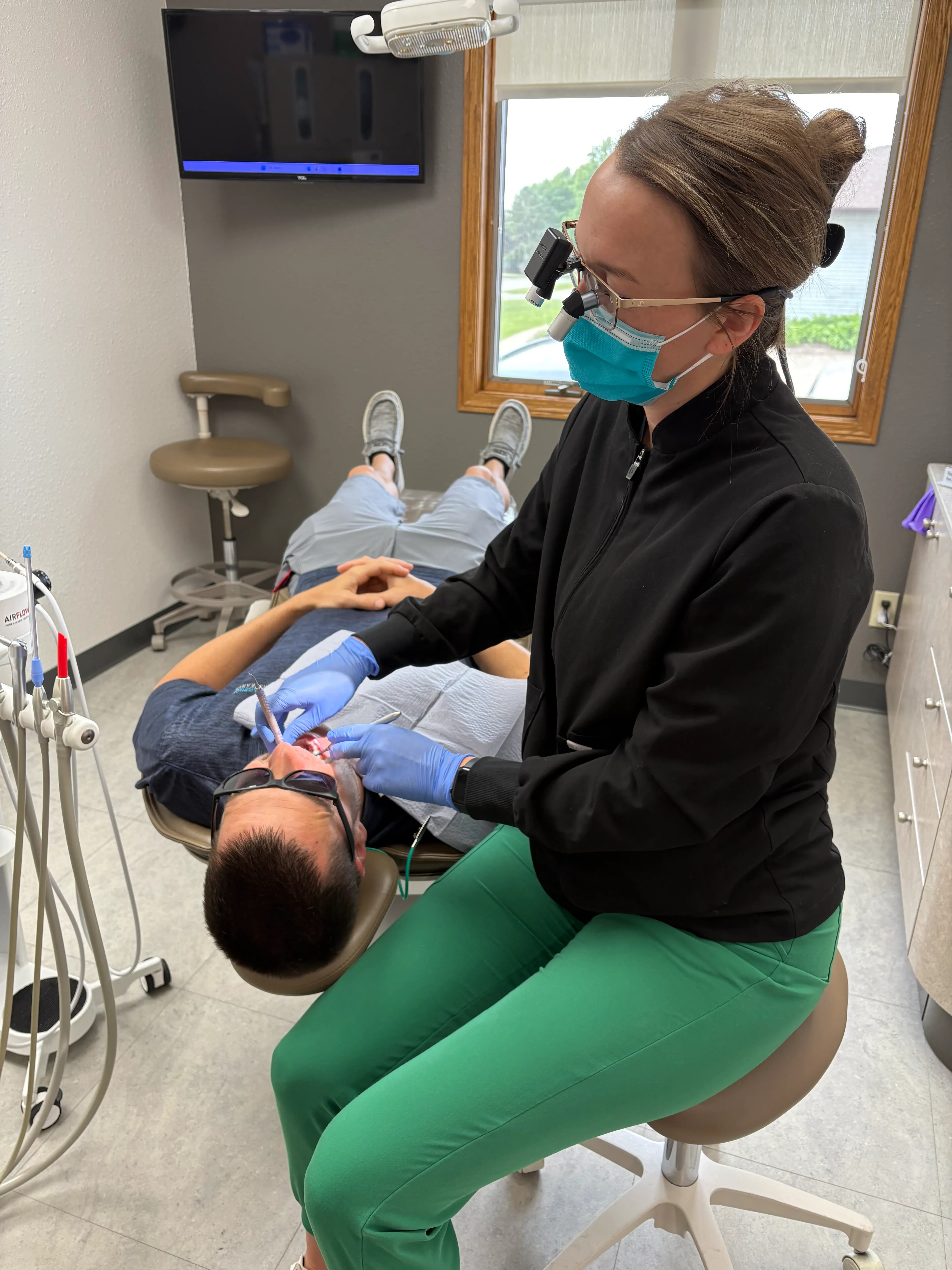 Treatment room at Markham Family Dental with a dental chair, X-ray unit and window