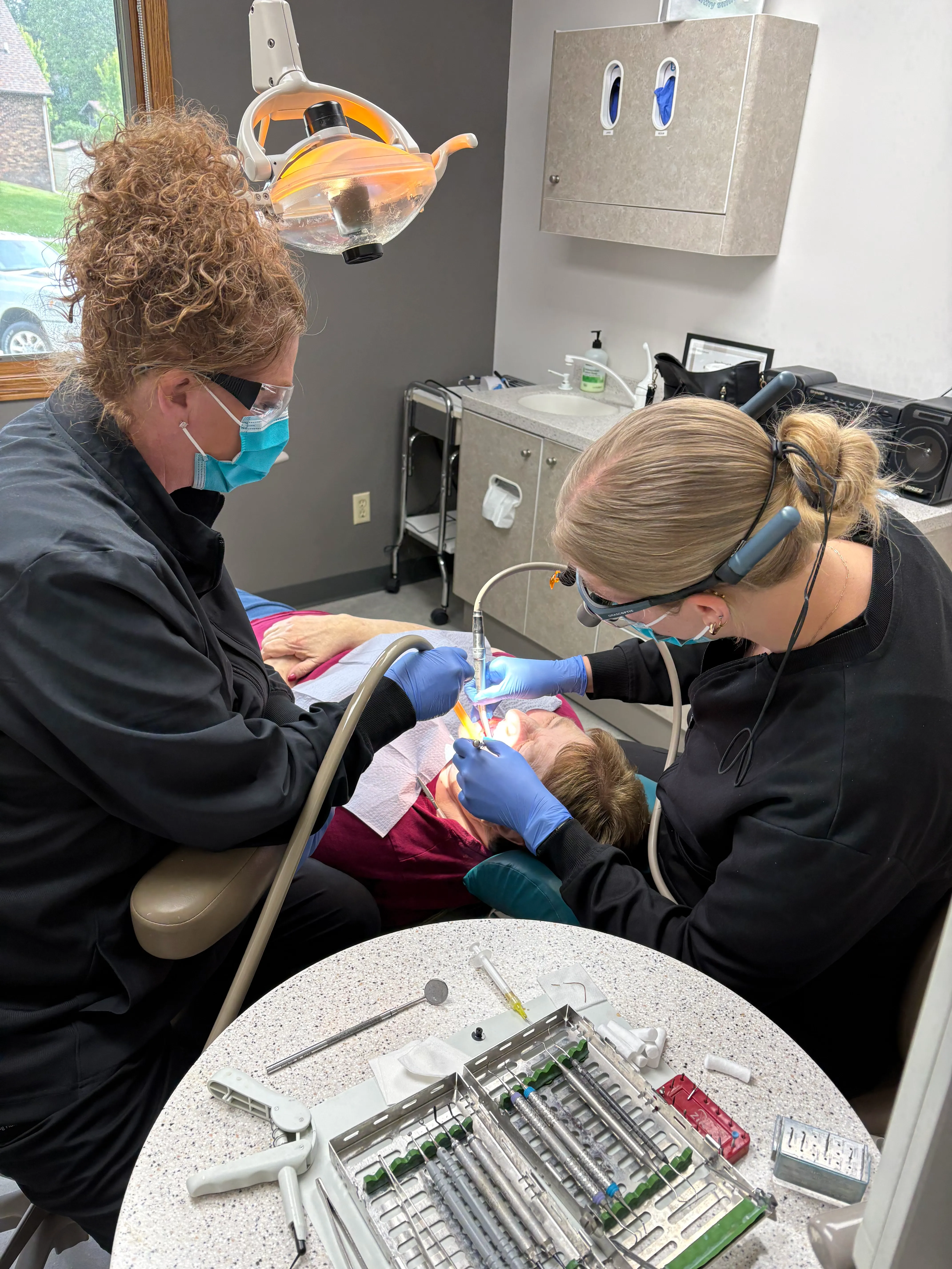 Two Markham Family Dental team members treating a young child in the dental chair