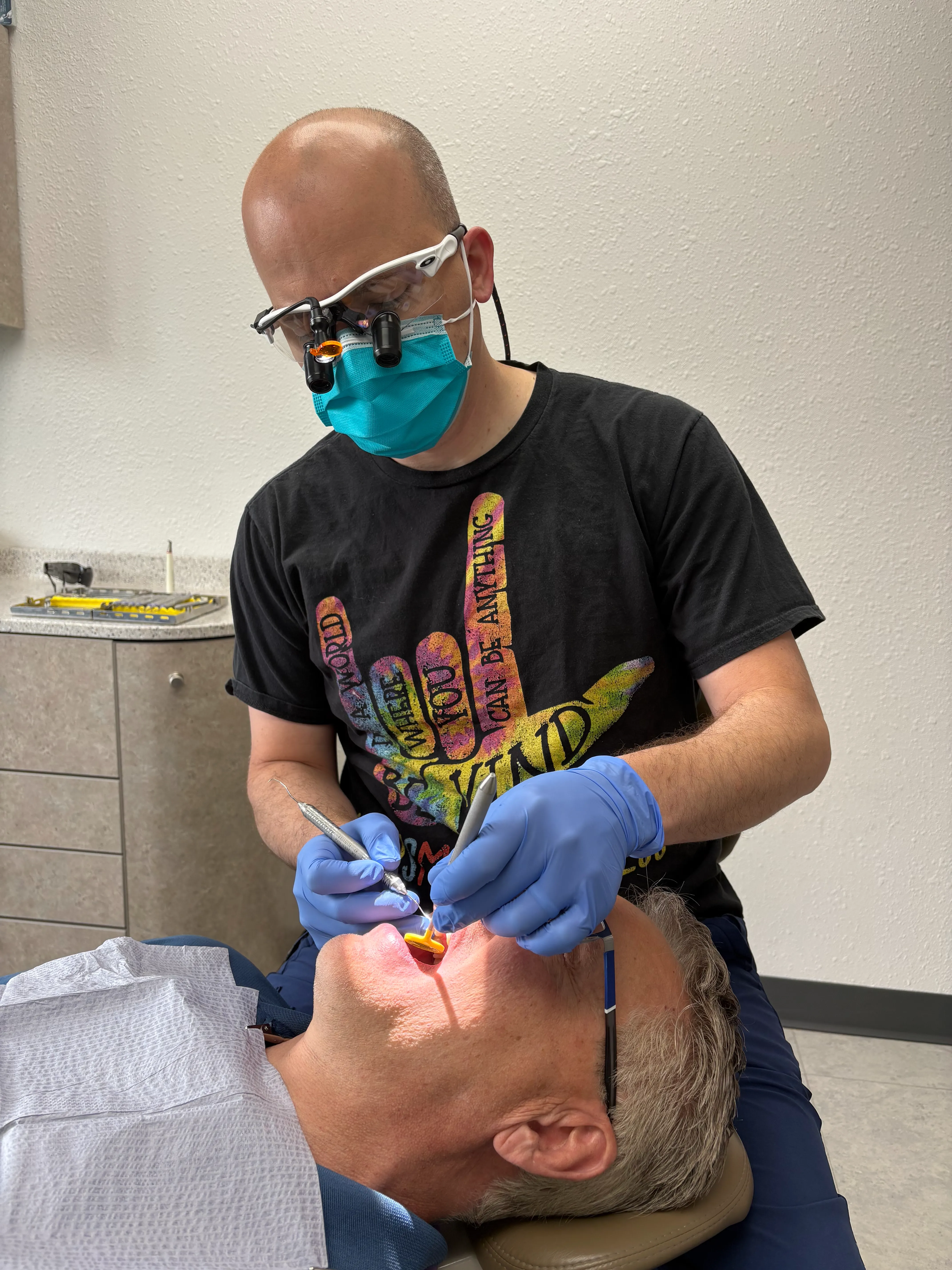 Dentist performing a dental procedure on a patient at Markham Family Dental
