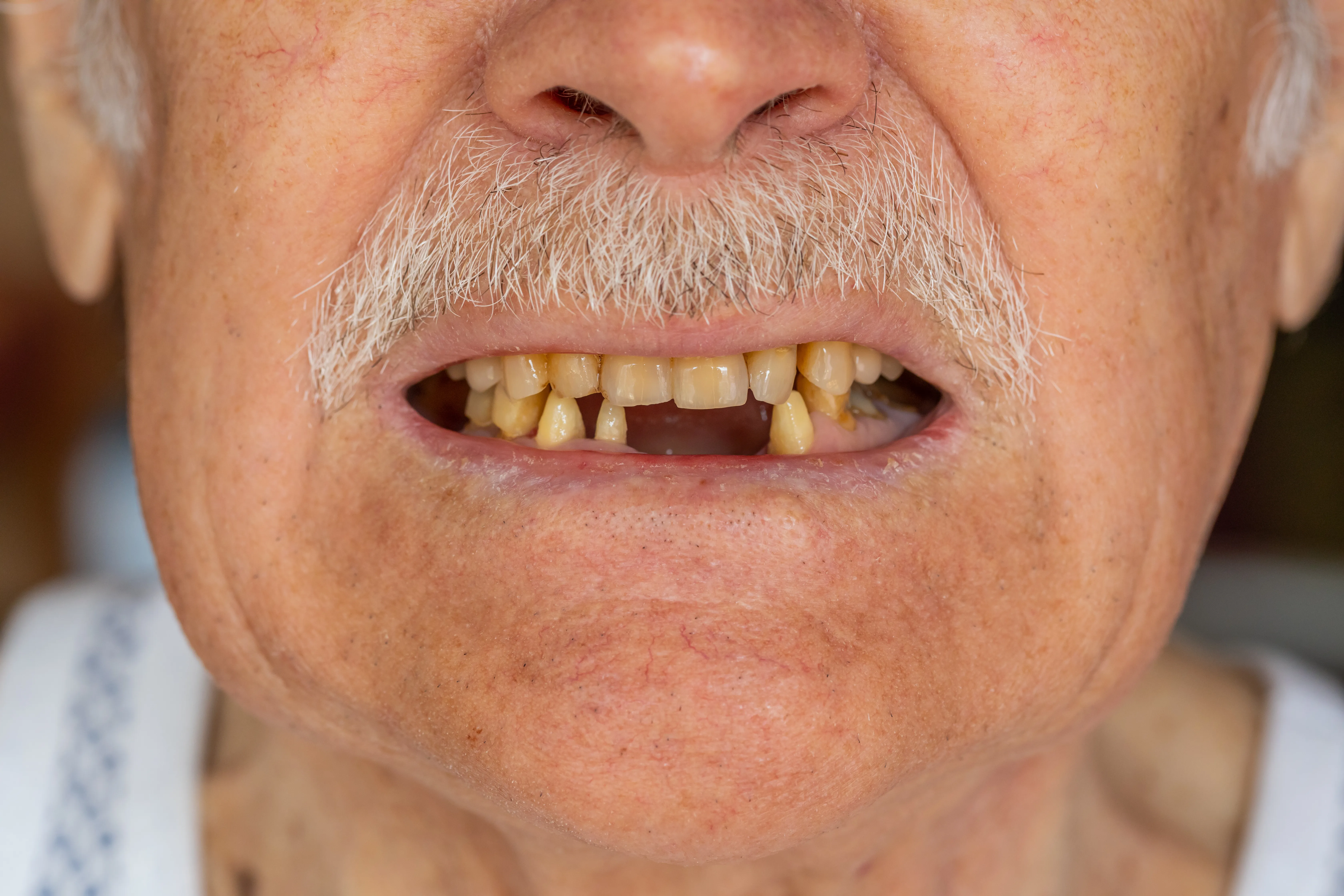 Close-up macro shot of toothless male smile mouth of senior mature man.