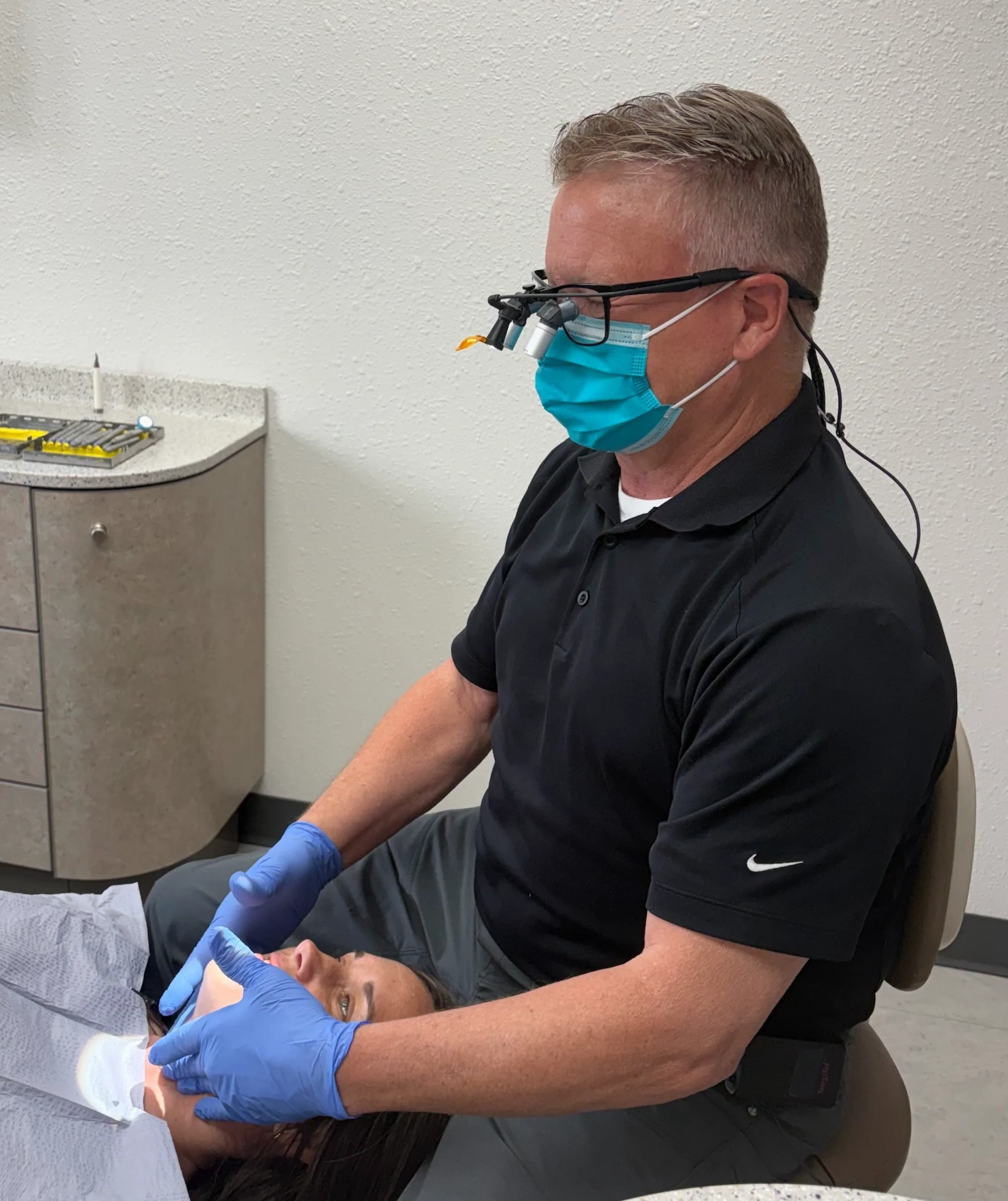 Dental team member examining a patient's
