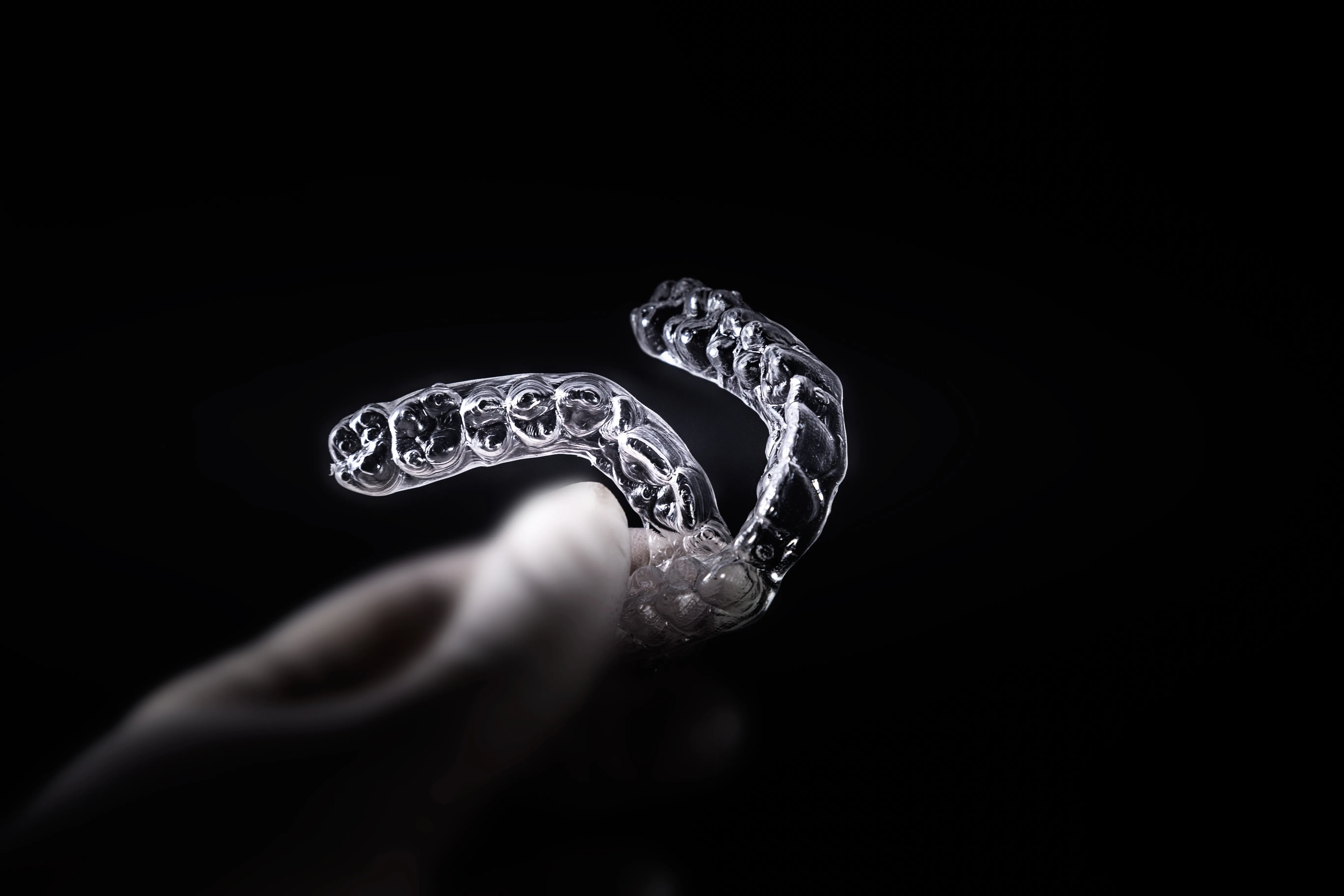 Person holding clear orthodontic aligner trays