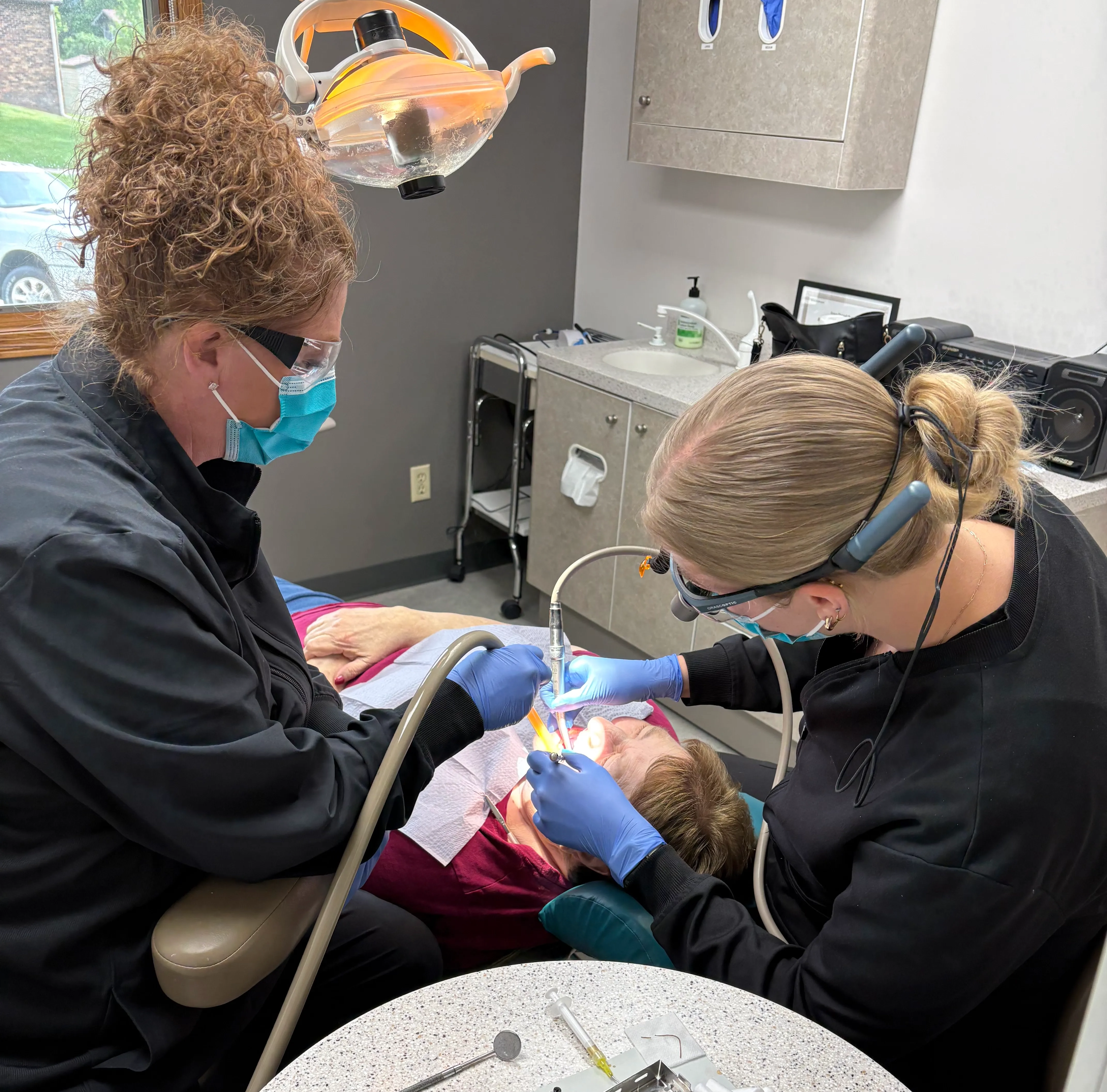 Dentist preparing a tooth-colored filling for a cavity in a back tooth