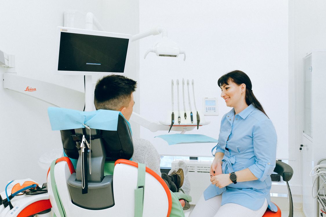 Dental patient discussing replacement options for a missing tooth with a dentist