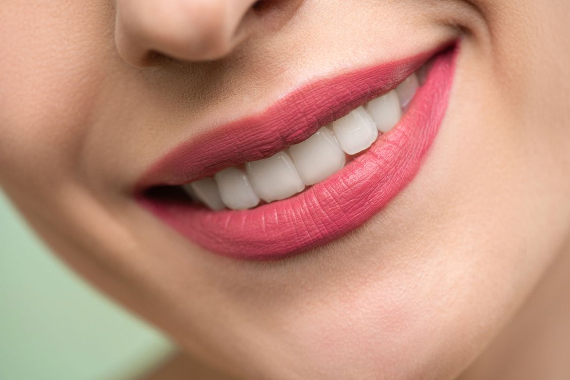 Smiling patient with natural front teeth during a cosmetic dental consultation