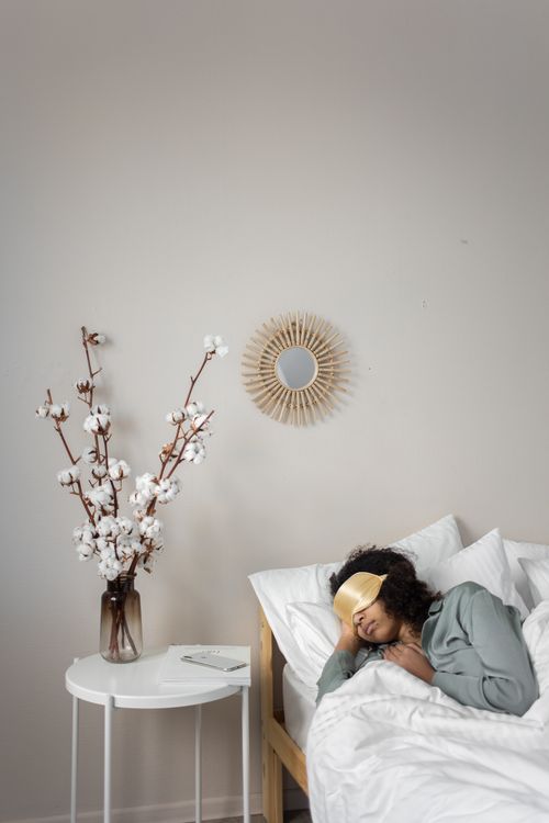 Adult sleeping in bed, representing nighttime teeth grinding and sleep bruxism