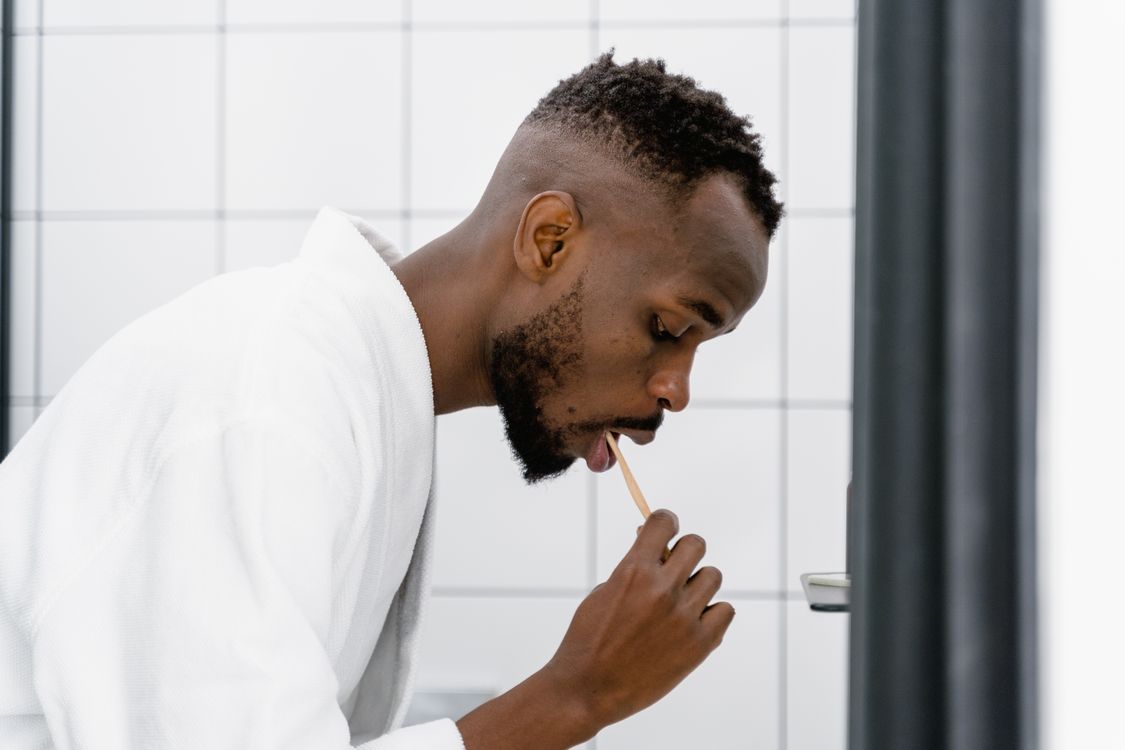 Young adult brushing teeth as part of a daily morning routine