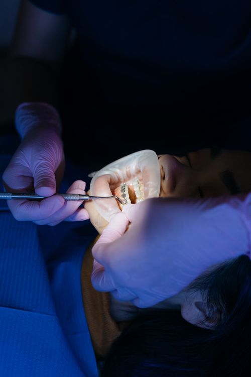 Dentist examining a patient's teeth for cavities and enamel health