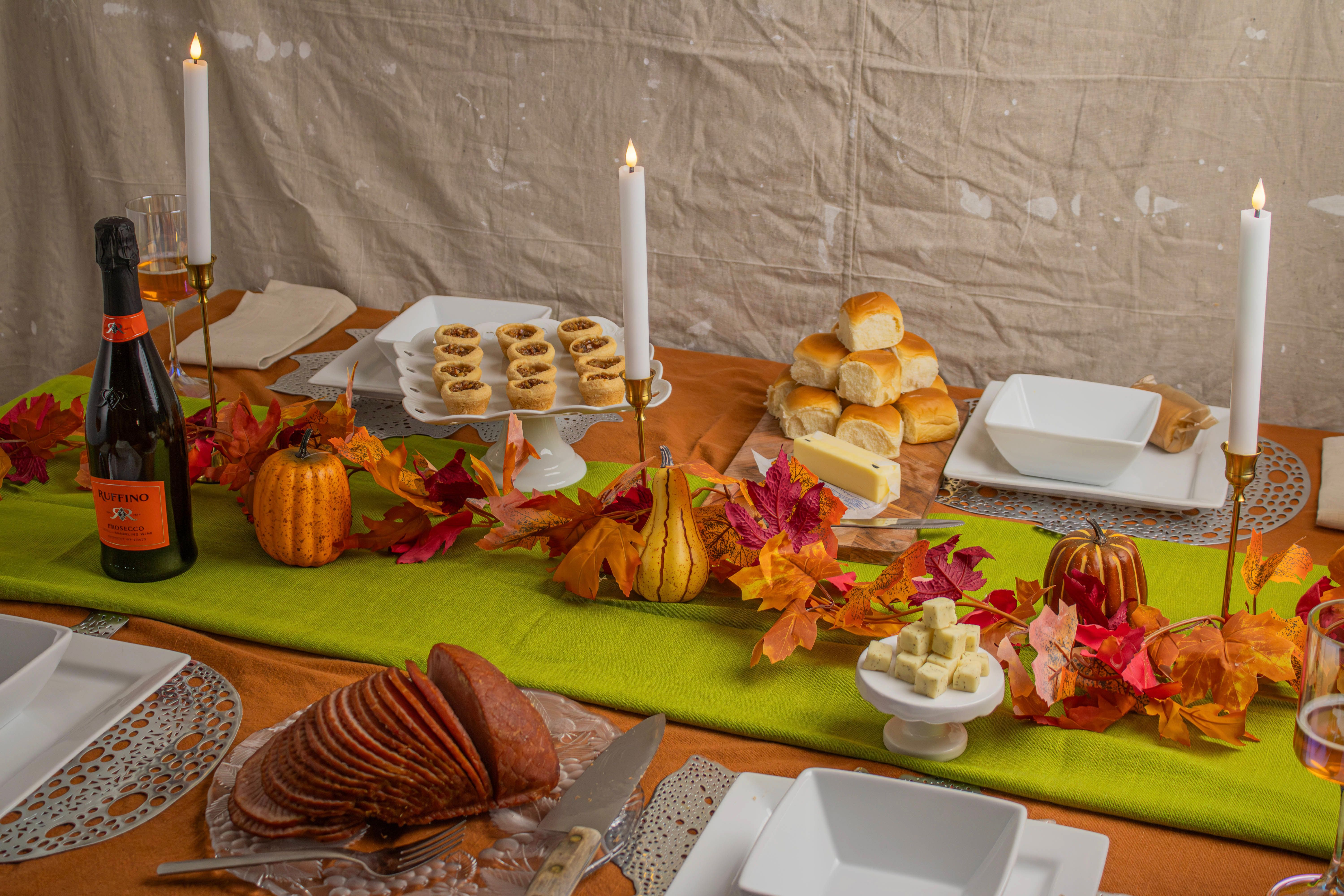 Thanksgiving table set with autumn decorations and a festive meal