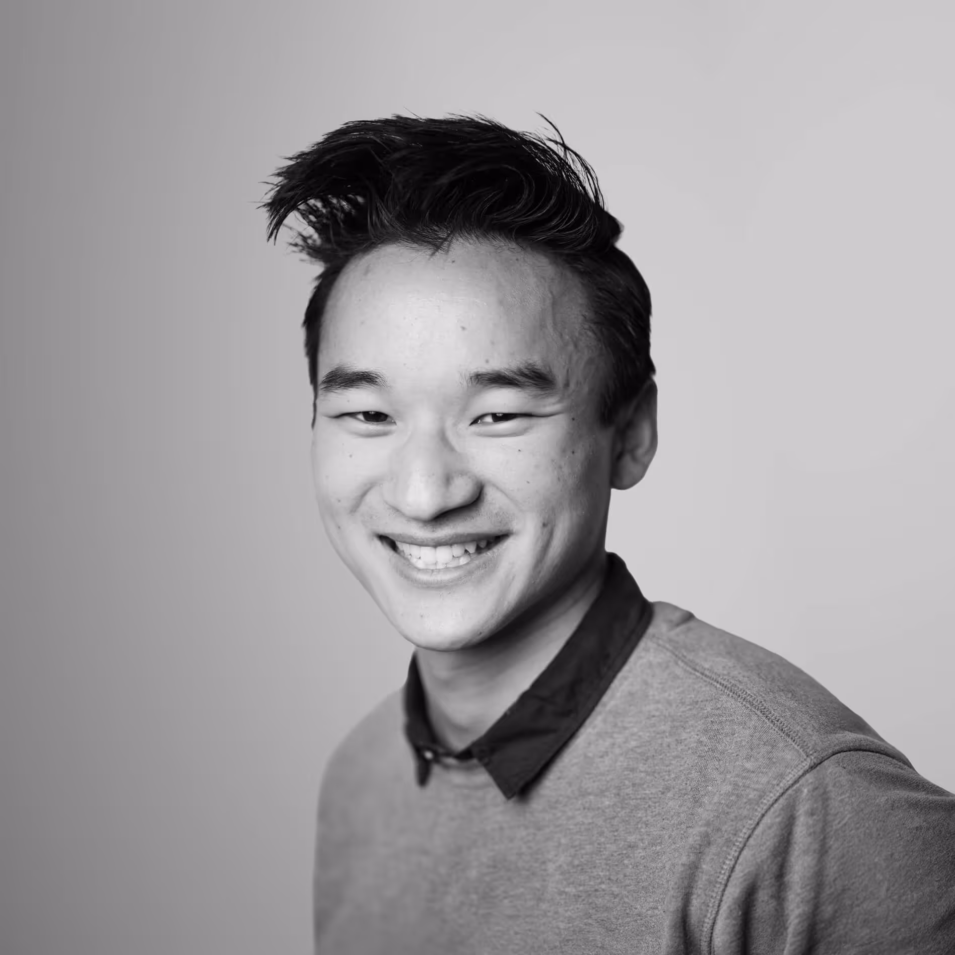A group of men dressed in semi-formal attire ordering food at a decorated street food truck labeled Indian Soulfood at night.